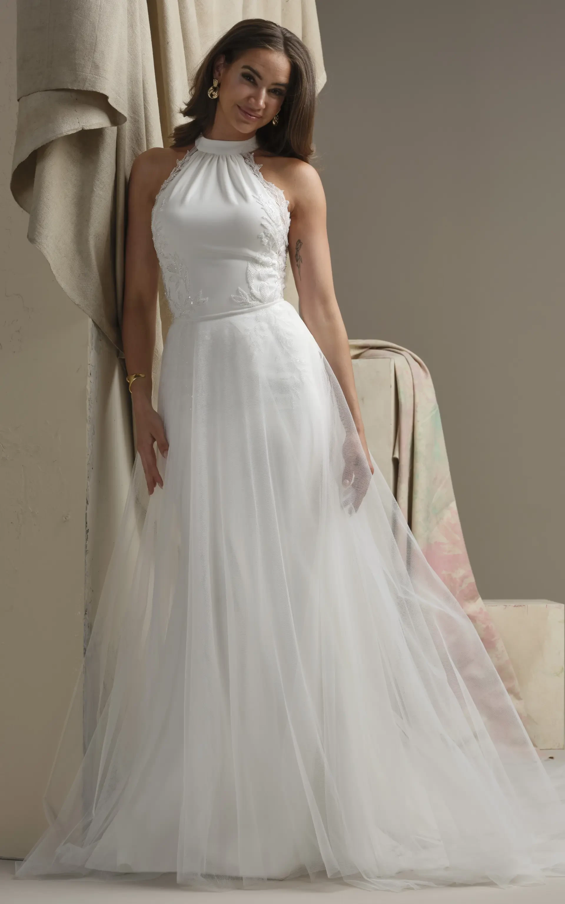 Model In A Studio Wearing Plain Tulle Overskirt By Maggie Sottero