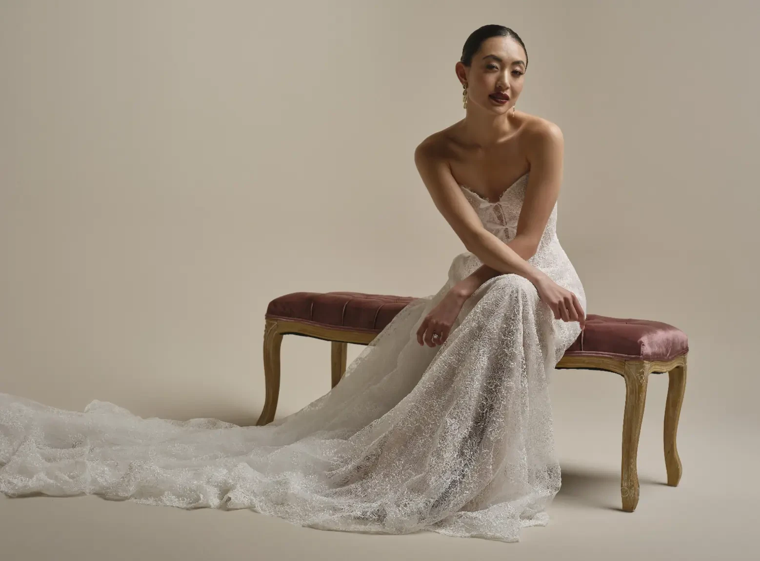 Model Sitting In A Studio Wearing Lace With Bows Wedding Gown Called Granger By Sottero And Midgley