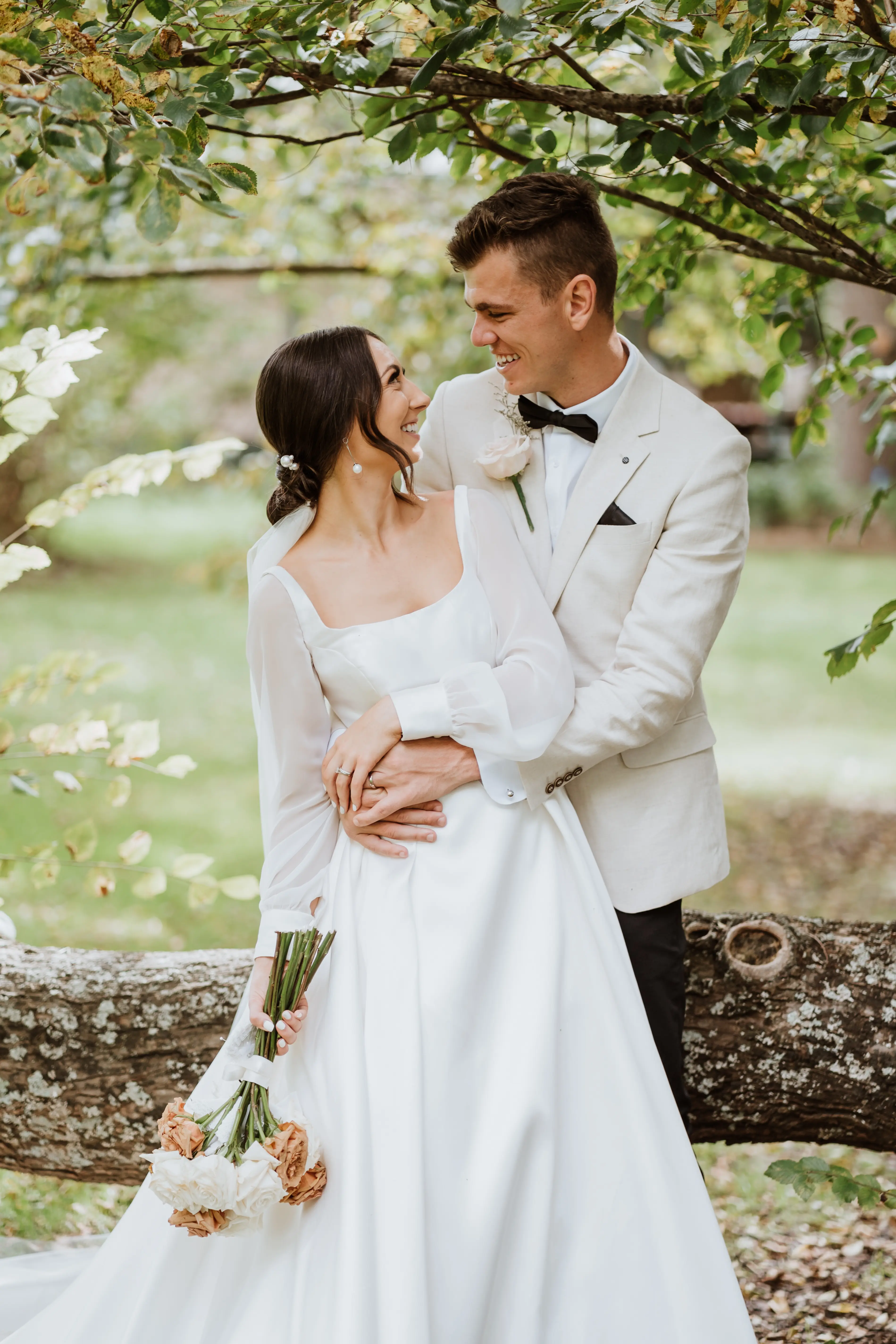Bride and groom looking at each other smiling.