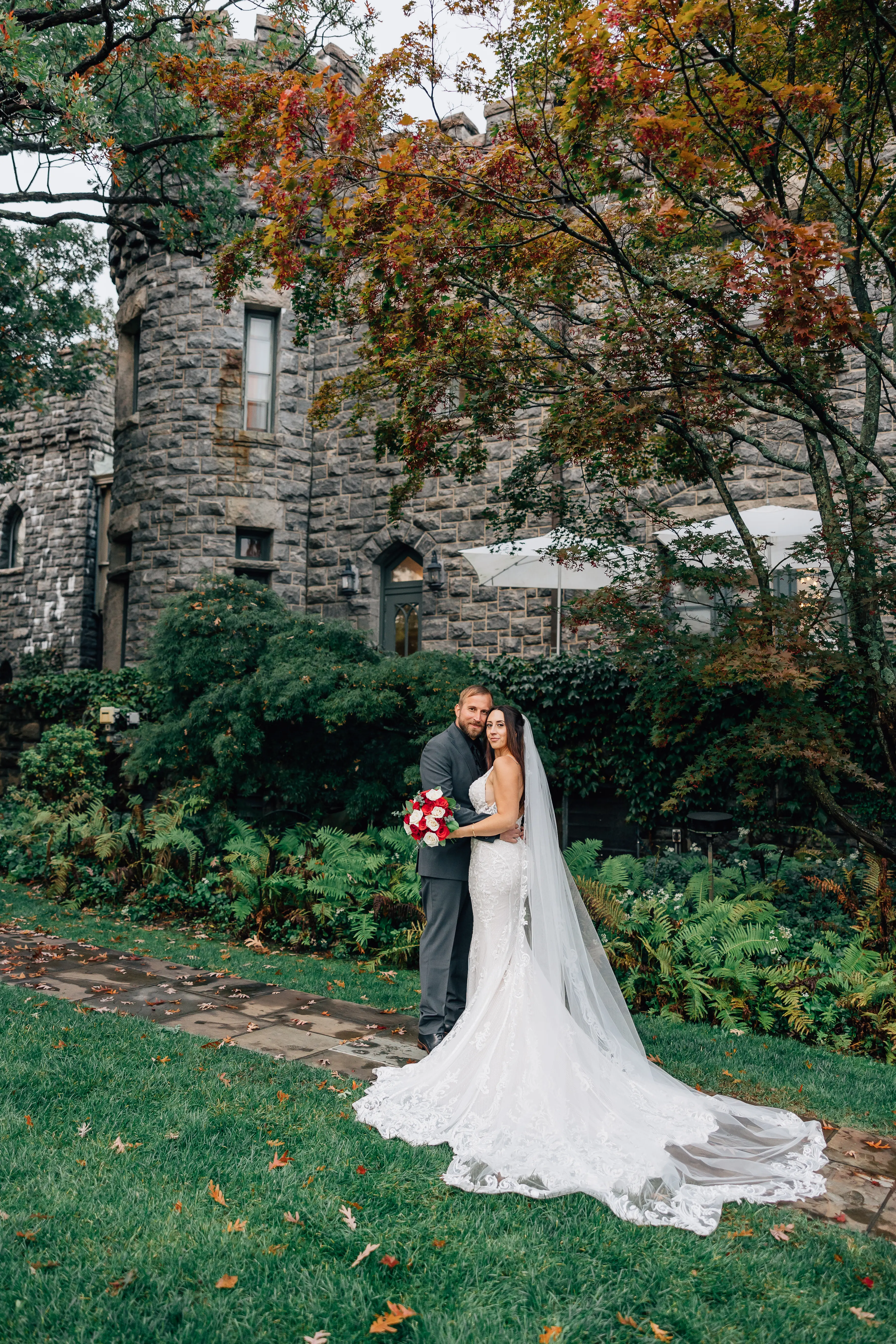 Groom Hugging Bride Wearing A Fitted Lace White Wedding Dress Named Veronique by Maggie Sottero