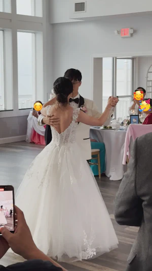 Bride wearing Harlem by Maggie Sottero dancing with her husband