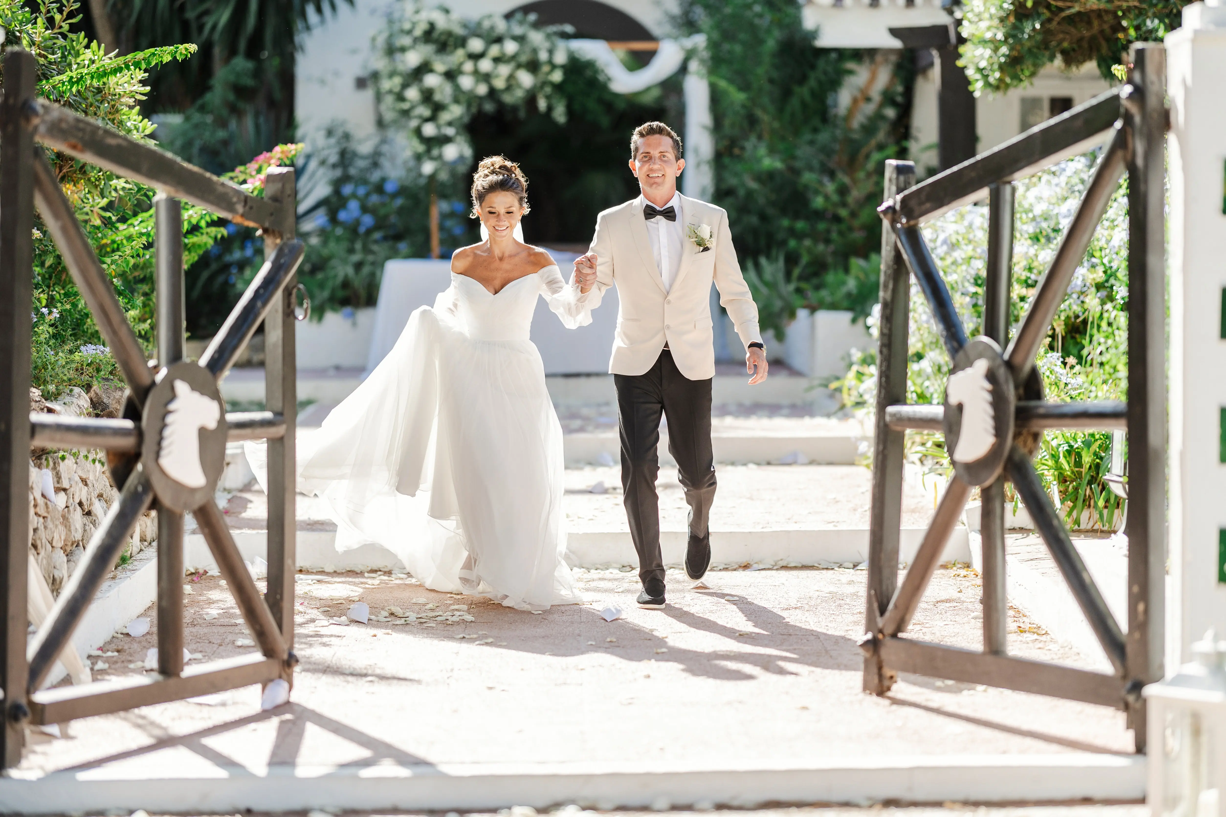 Bride Wearing Aline Wedding Dress Called Nerida By Sottero And Midgley Walking Hand In Hand With Groom