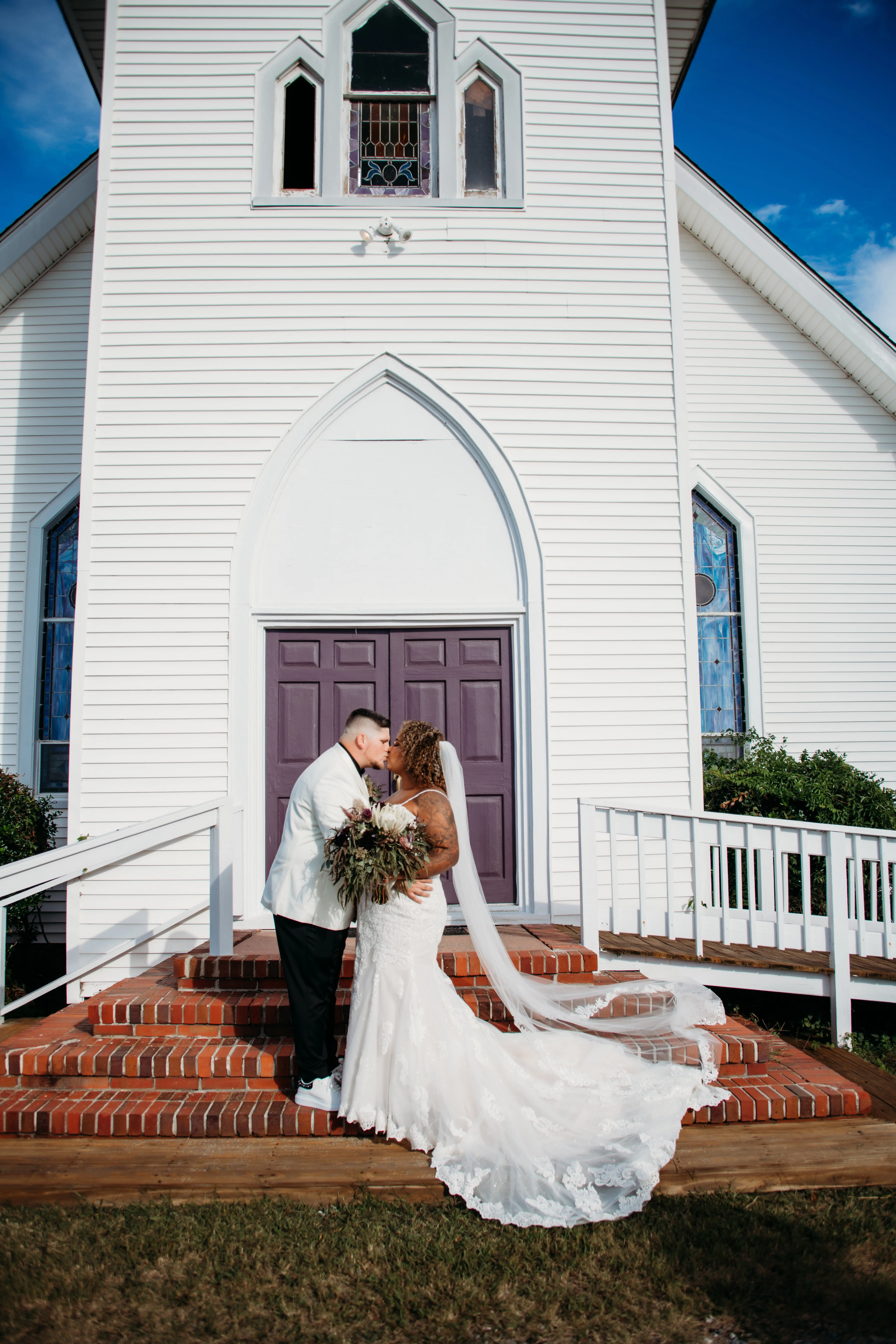 Groom Kissing Real Bride in Breaded Sparkly Lace Fit-and-Flare Dress with Scalloped Illusion Lace Train Called Fiona by Maggie Sottero