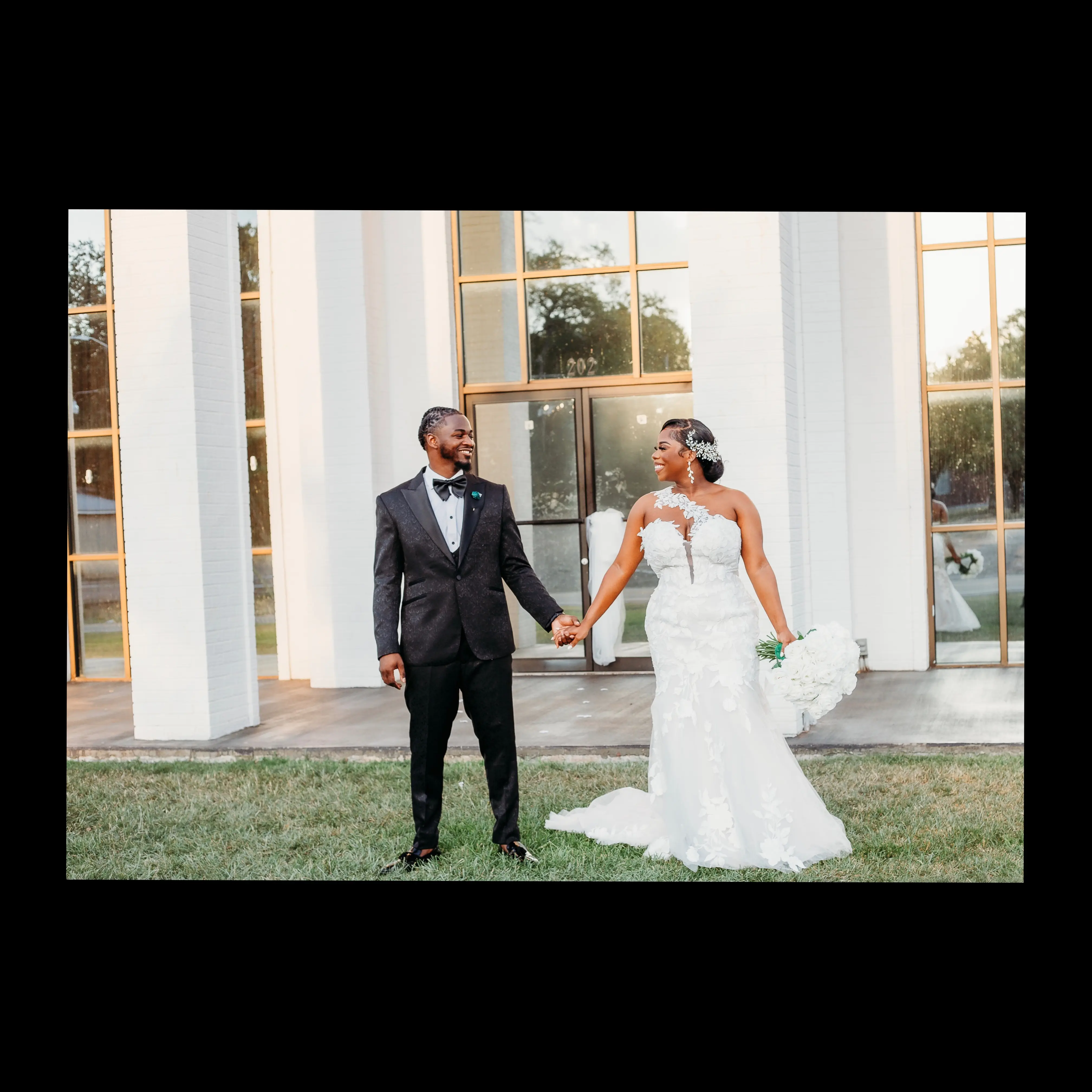 Bride wearing Hattie by Rebecca Ingram holding hands with her husband