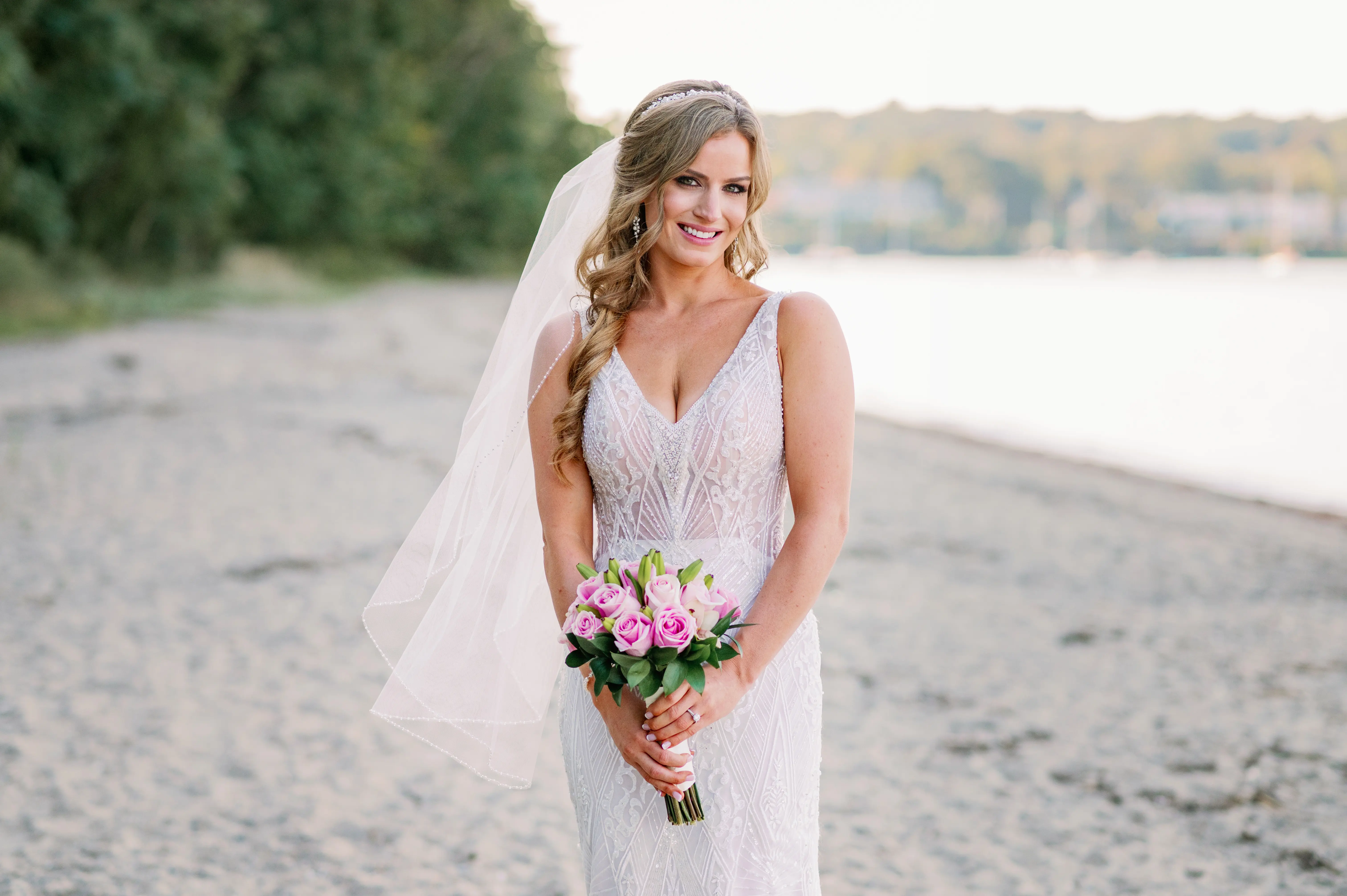 Bride with pretty pink bouquet wearing wedding dress called Elaine.