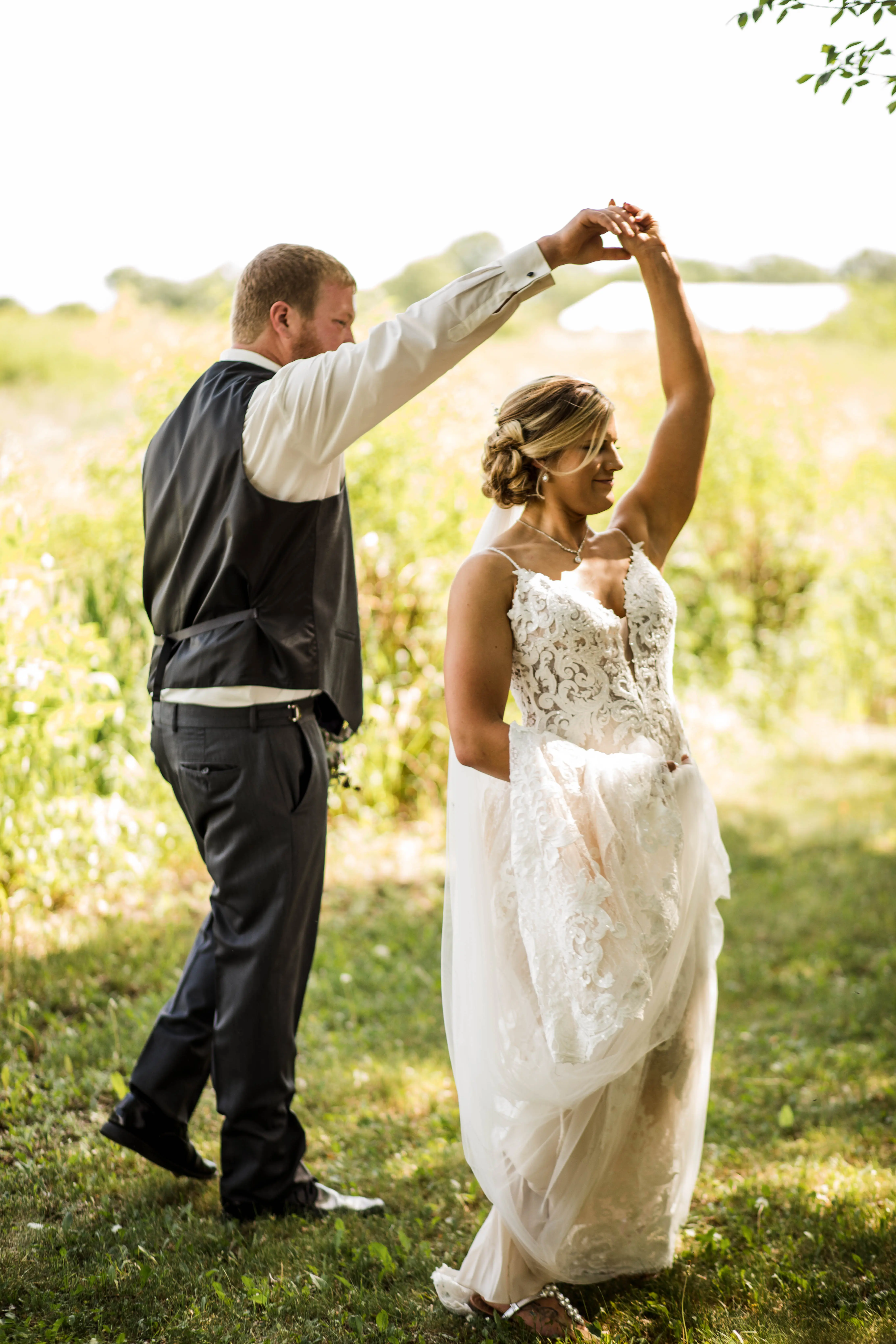 Bride with groom wearing romantic lace sheath wedding dress