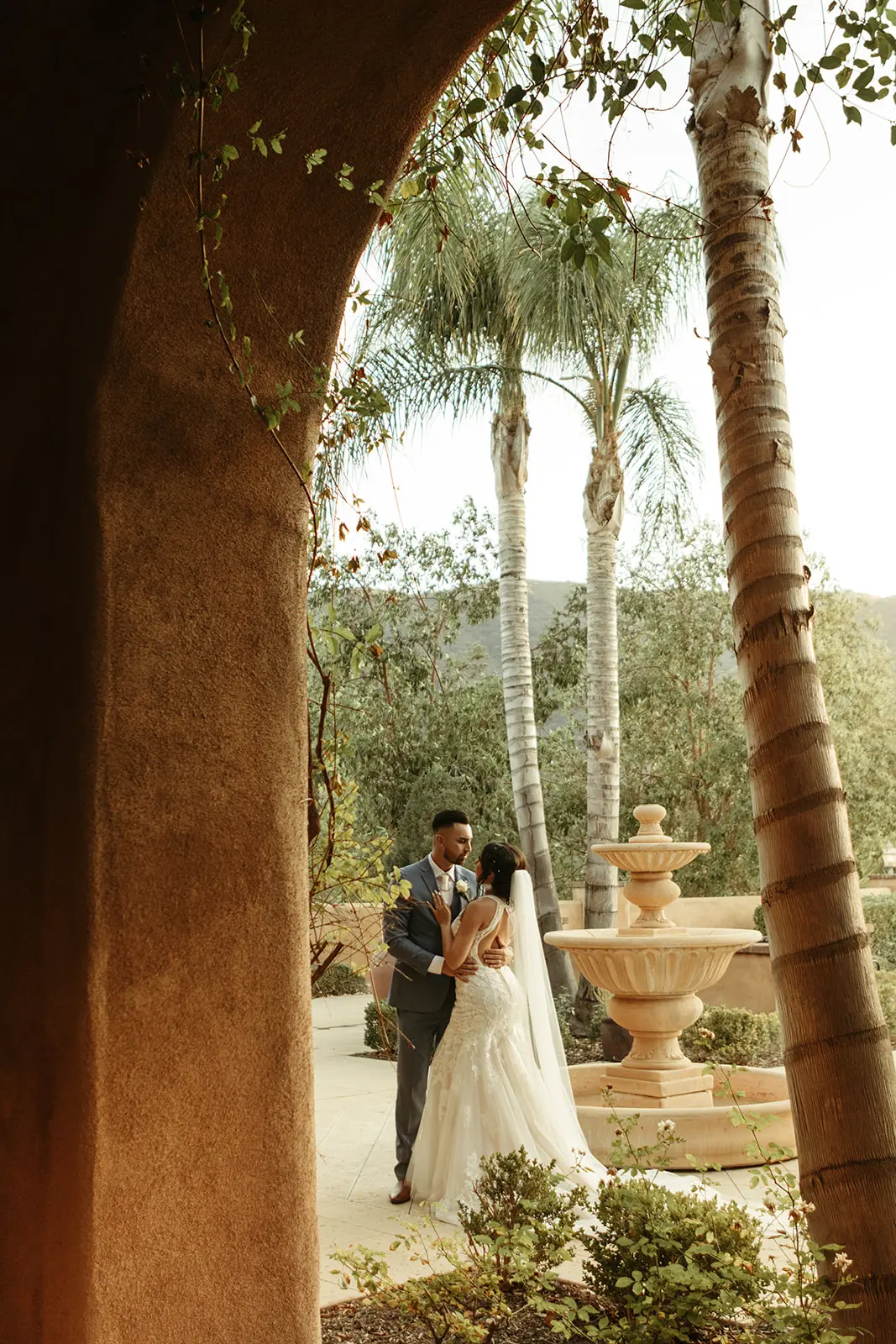 Bride and groom hugging close looking into each other's eyes.