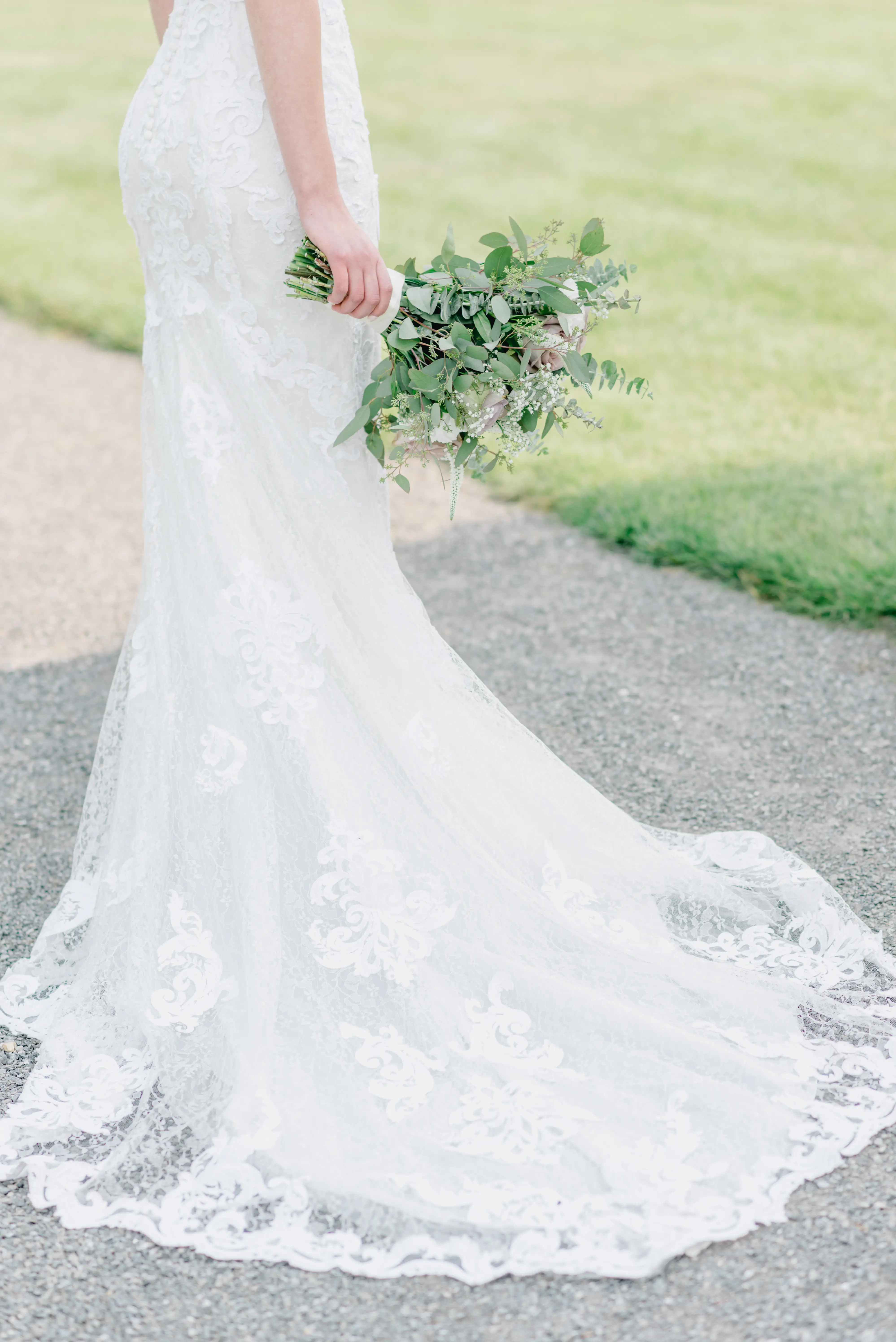 Bride with groom wearing lace sheath wedding dress