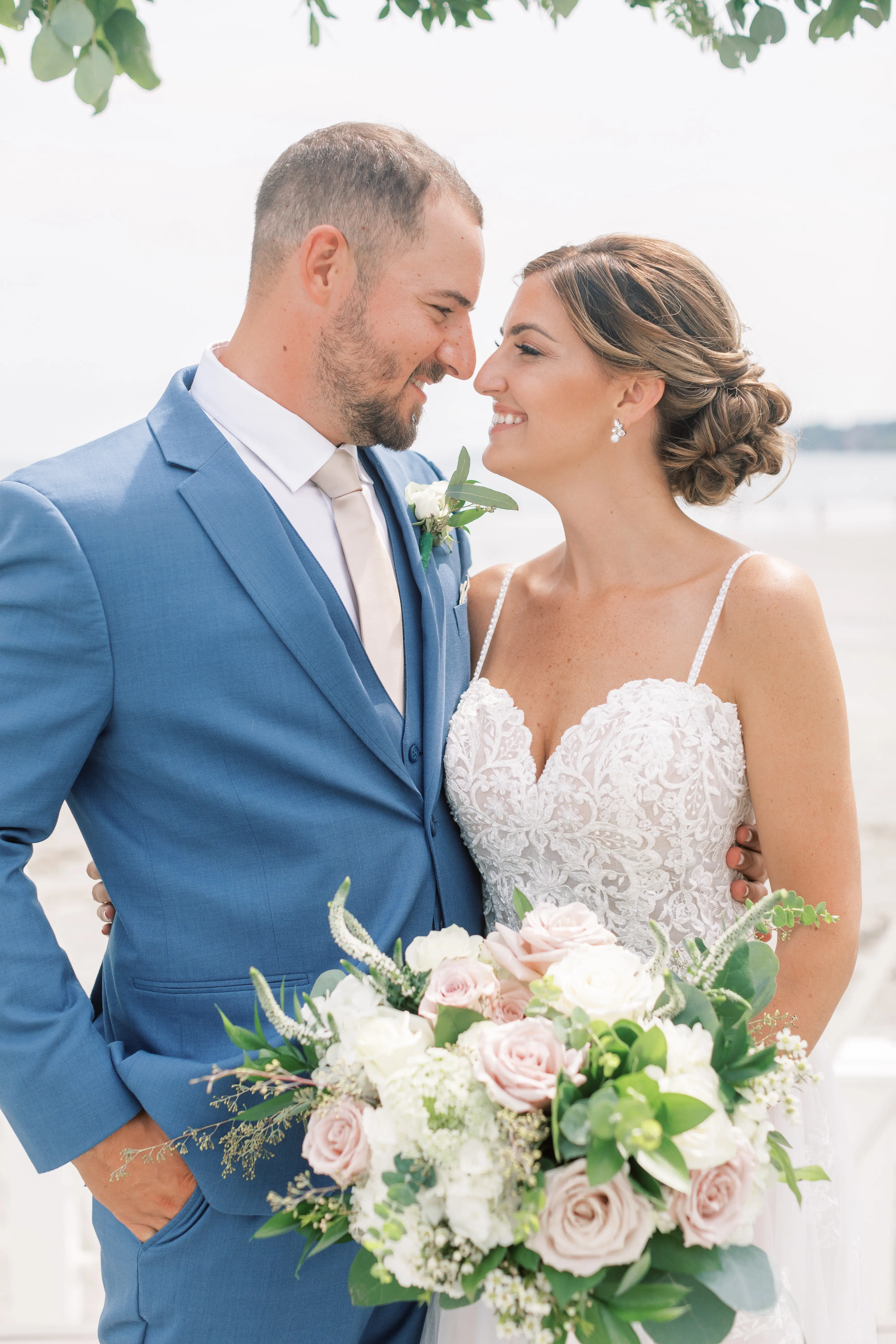 Bride Wearing Boho Sheath Wedding Dress Called Marisol By Rebecca Ingram With Groom Holding White And Pink Bouquet
