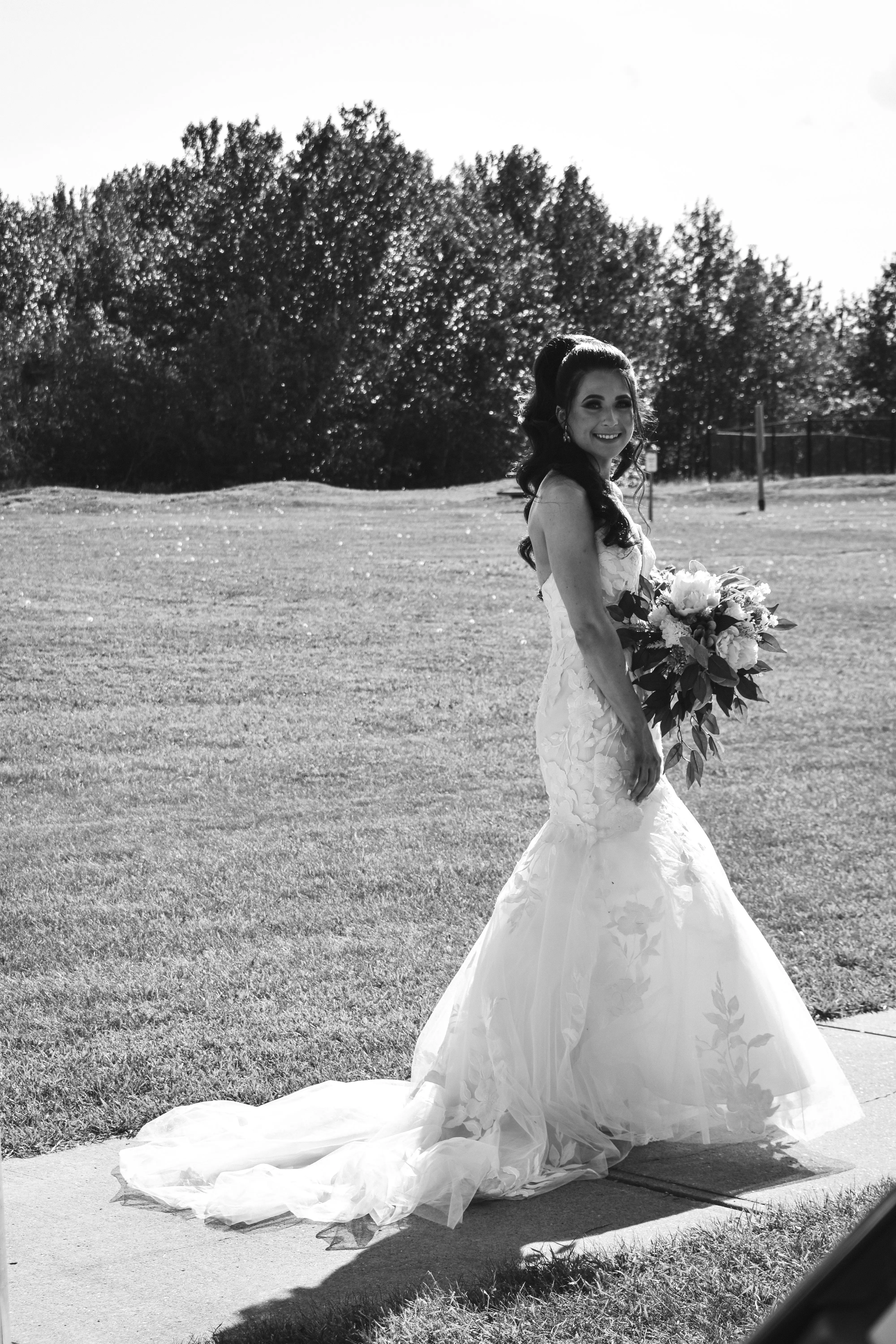 Bride Wearing Lace Mermaid Wedding Dress Called Hattie By Rebecca Ingram Holding Bouquet