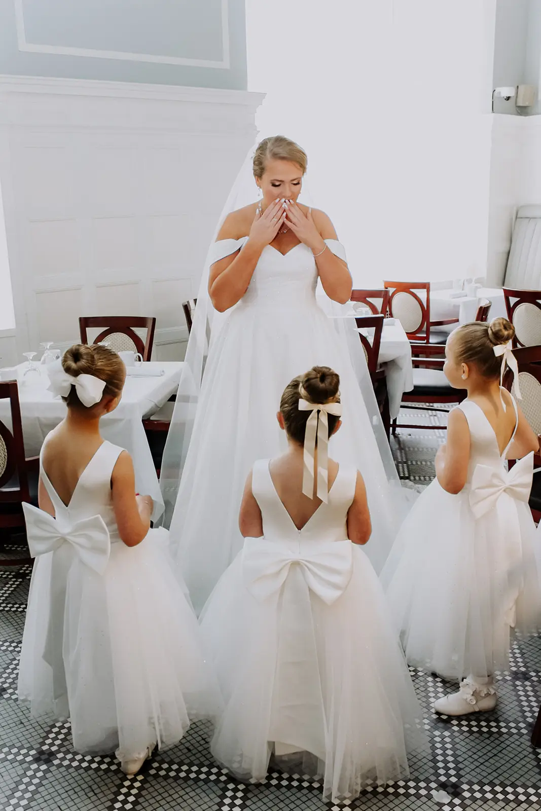 Bride wearing Anniston by Maggie Sottero surrounded by her flower girls