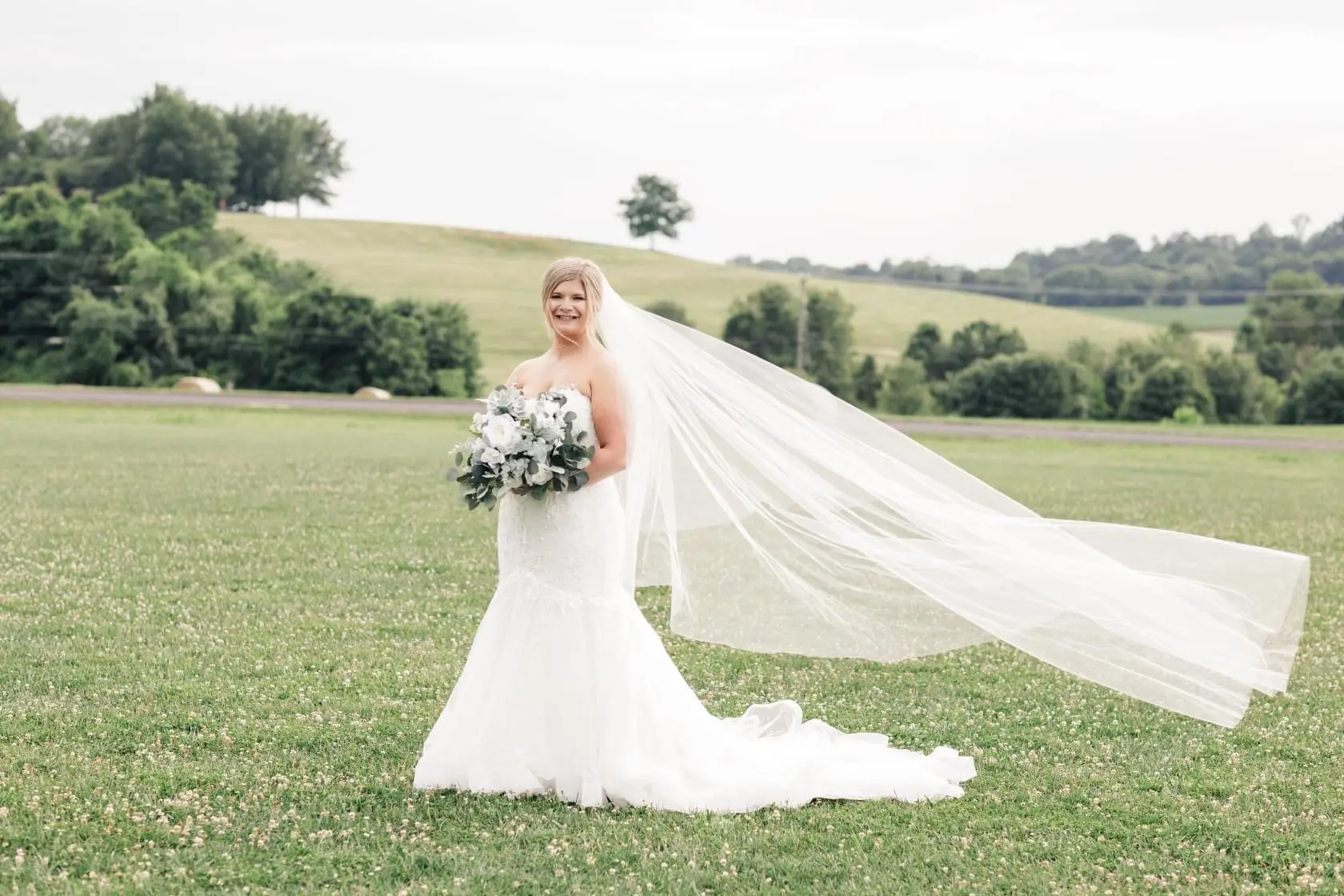Bride wearing glamorous plus size mermaid wedding dress