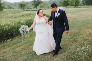 Bride wearing Fiona wedding dress by Maggie Sottero walking with her husband