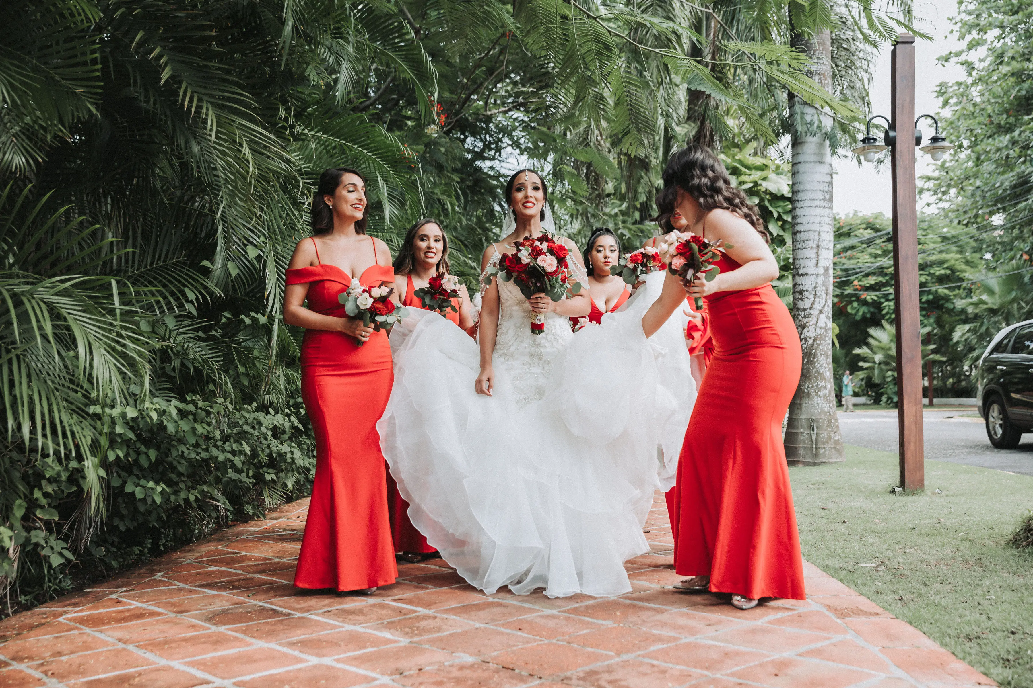Bride with bridesmaids wearing glamorous mermaid wedding dress