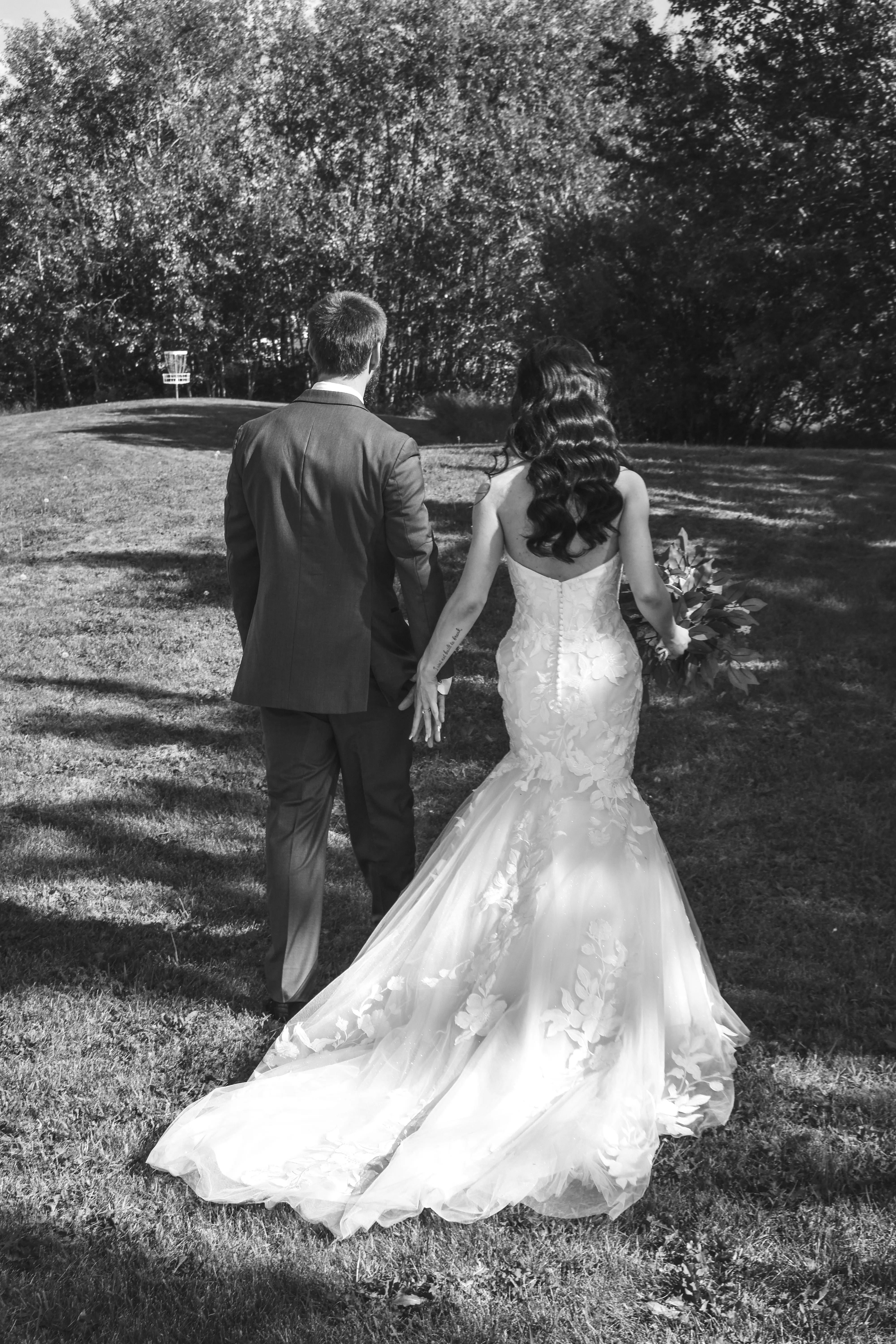 Bride Wearing Lace Mermaid Wedding Dress Called Hattie By Rebecca Ingram Walking With Groom