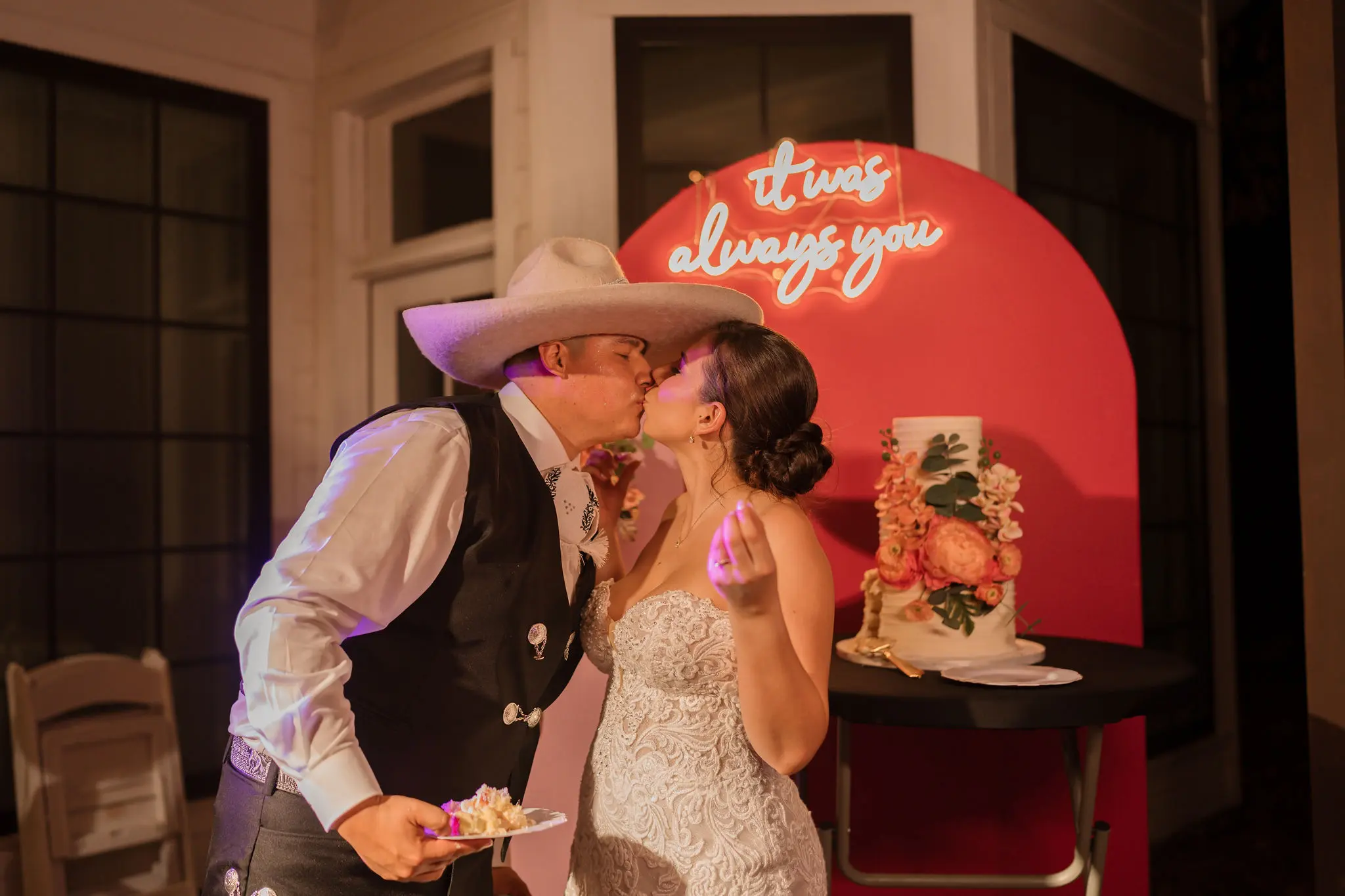 Bride wearing Fiona wedding dress by Maggie Sottero eating cake