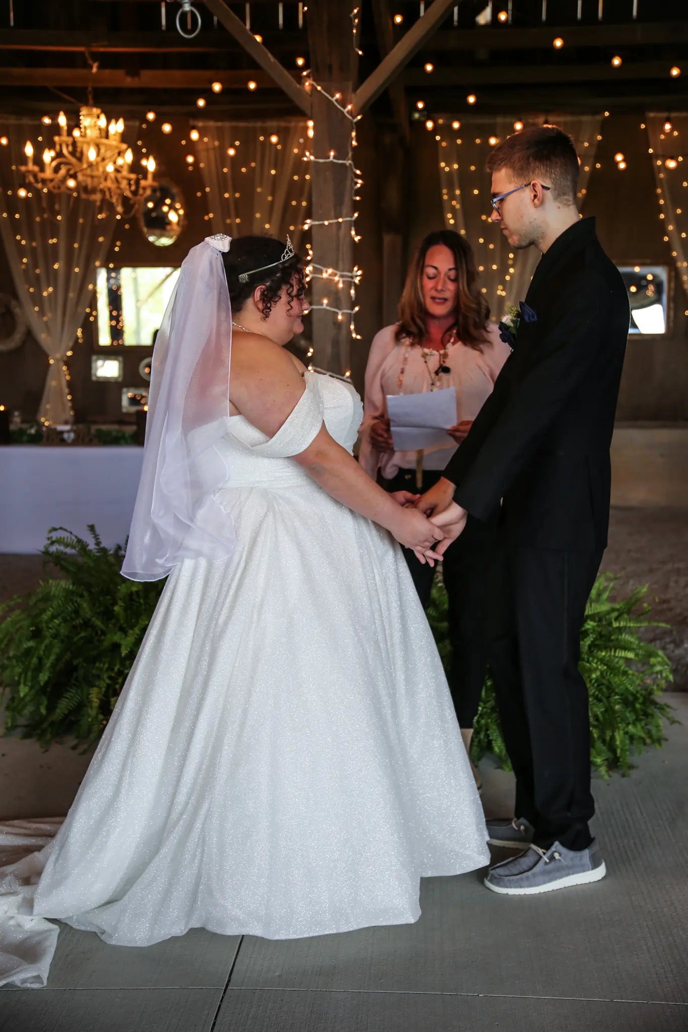 Bride wearing Anniston by Maggie Sottero holding hands with her husband
