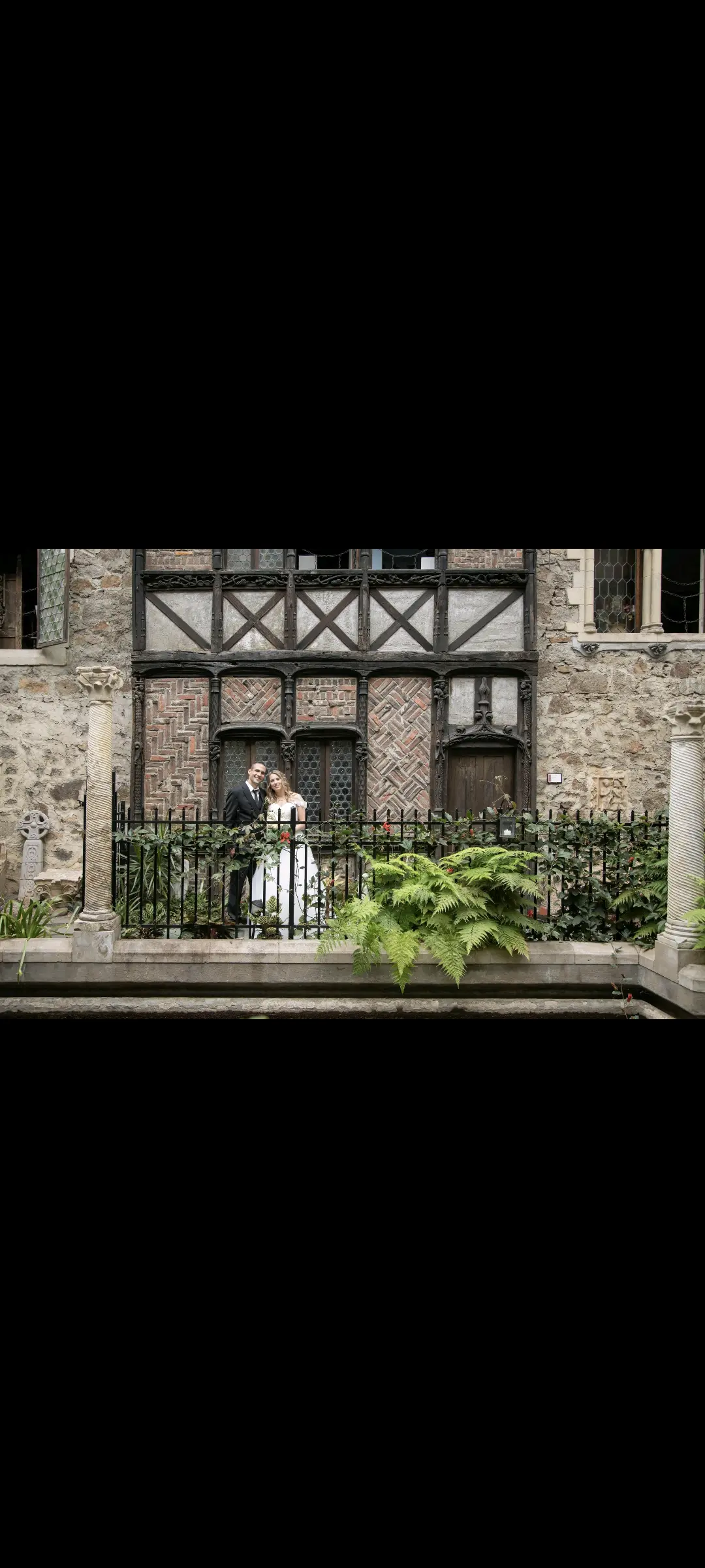 Bride wearing Harlem wedding dress by Maggie Sottero with her husband at their venue
