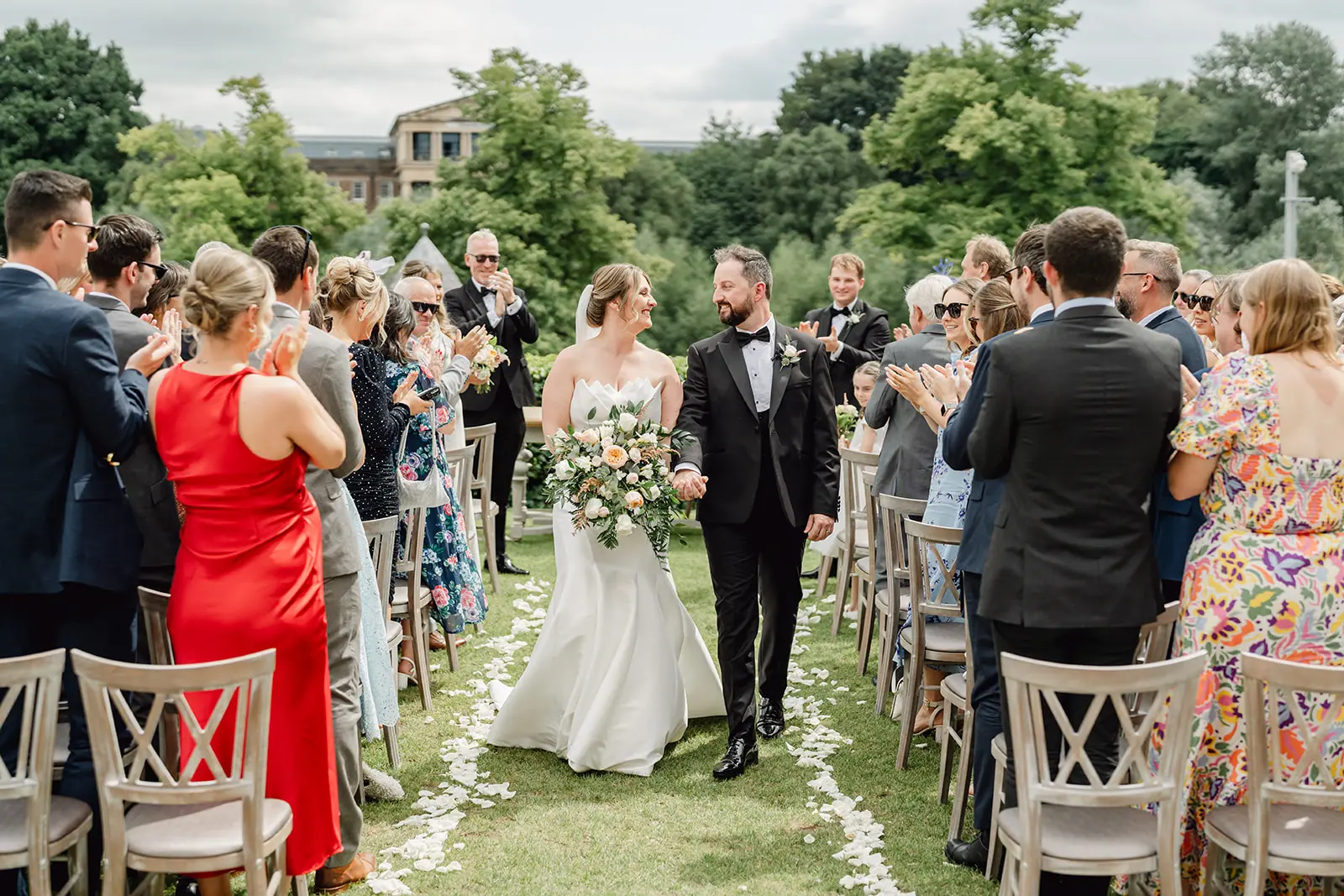 Bride Wearing Modern Wedding Dress Called Marilyn By Sottero And Midgley With Groom Walking Down The Aisle