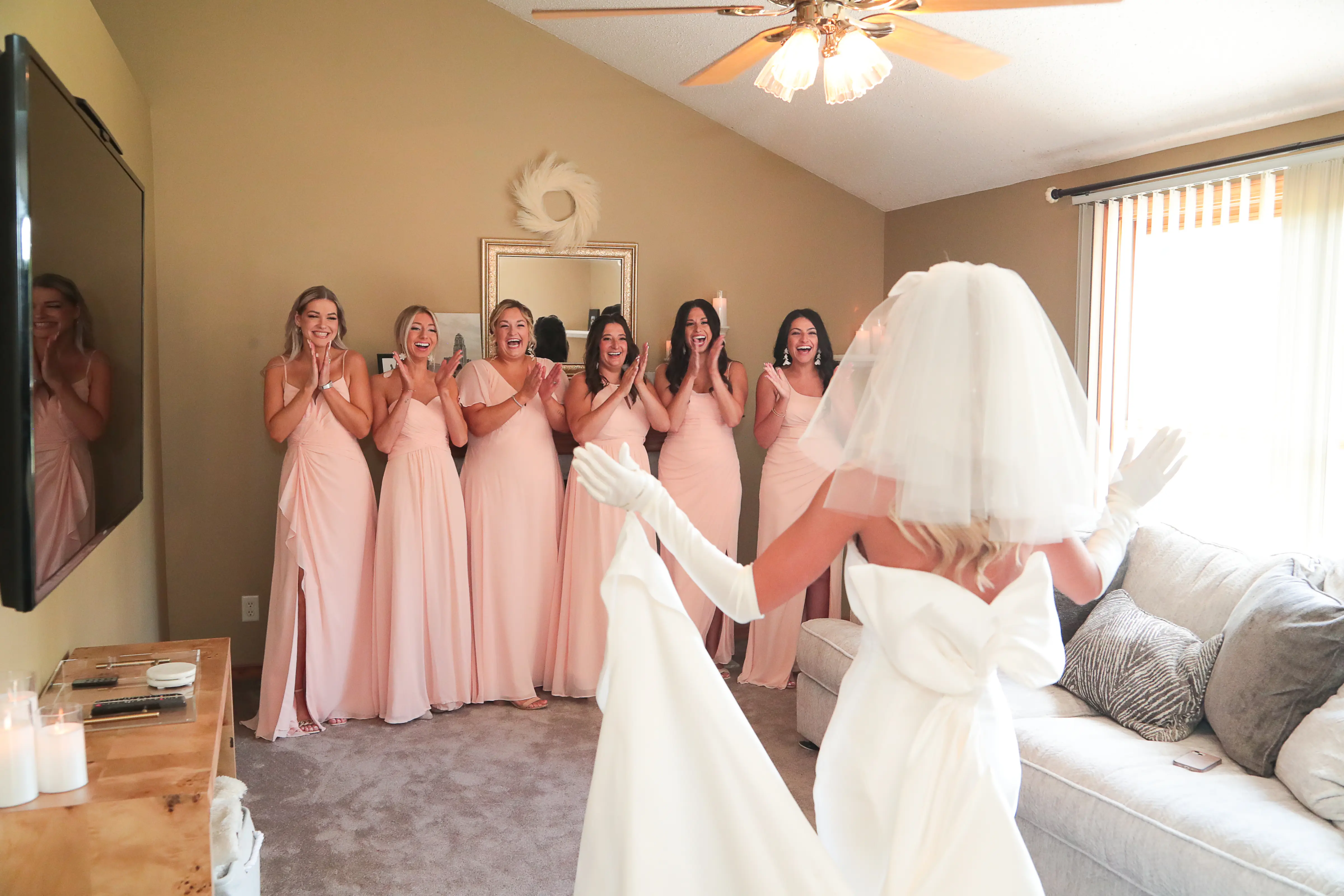 Bride In Simple Satin Wedding Dress Called Mitchell By Maggie Sottero With Bridal Gloves And Veil With Bridesmaids In Pink