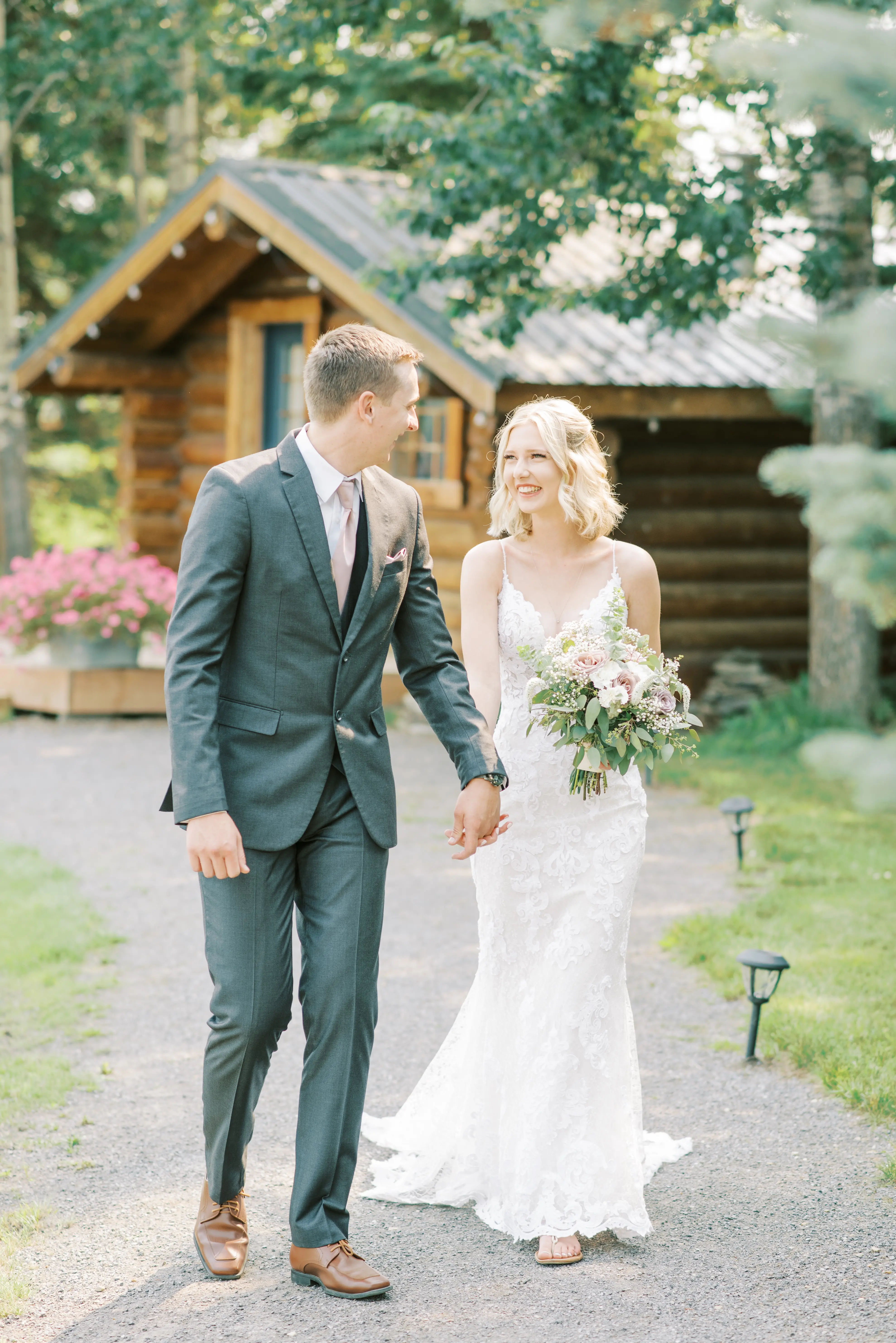 Bride with groom wearing lace sheath wedding dress