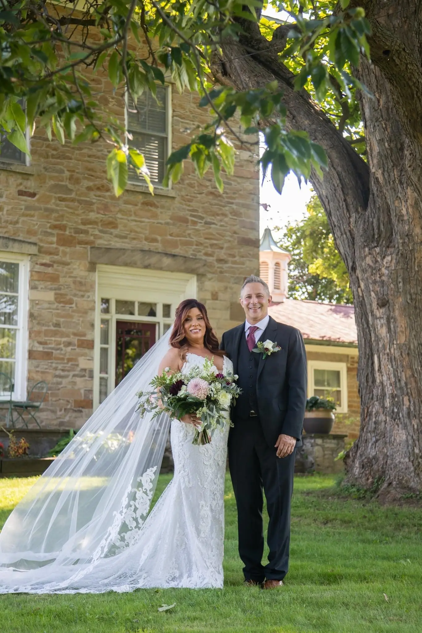 Bride Wearing Sexy Mermaid Wedding Dress Called Tuscany By Maggie Sottero Poses With Groom Outside