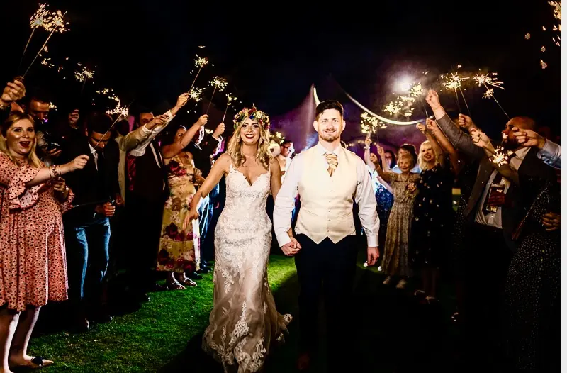 Groom and Bride Send Off with Sparklers Wearing Elegant Fit-and-Flare Bridal Dress by Maggie Sottero