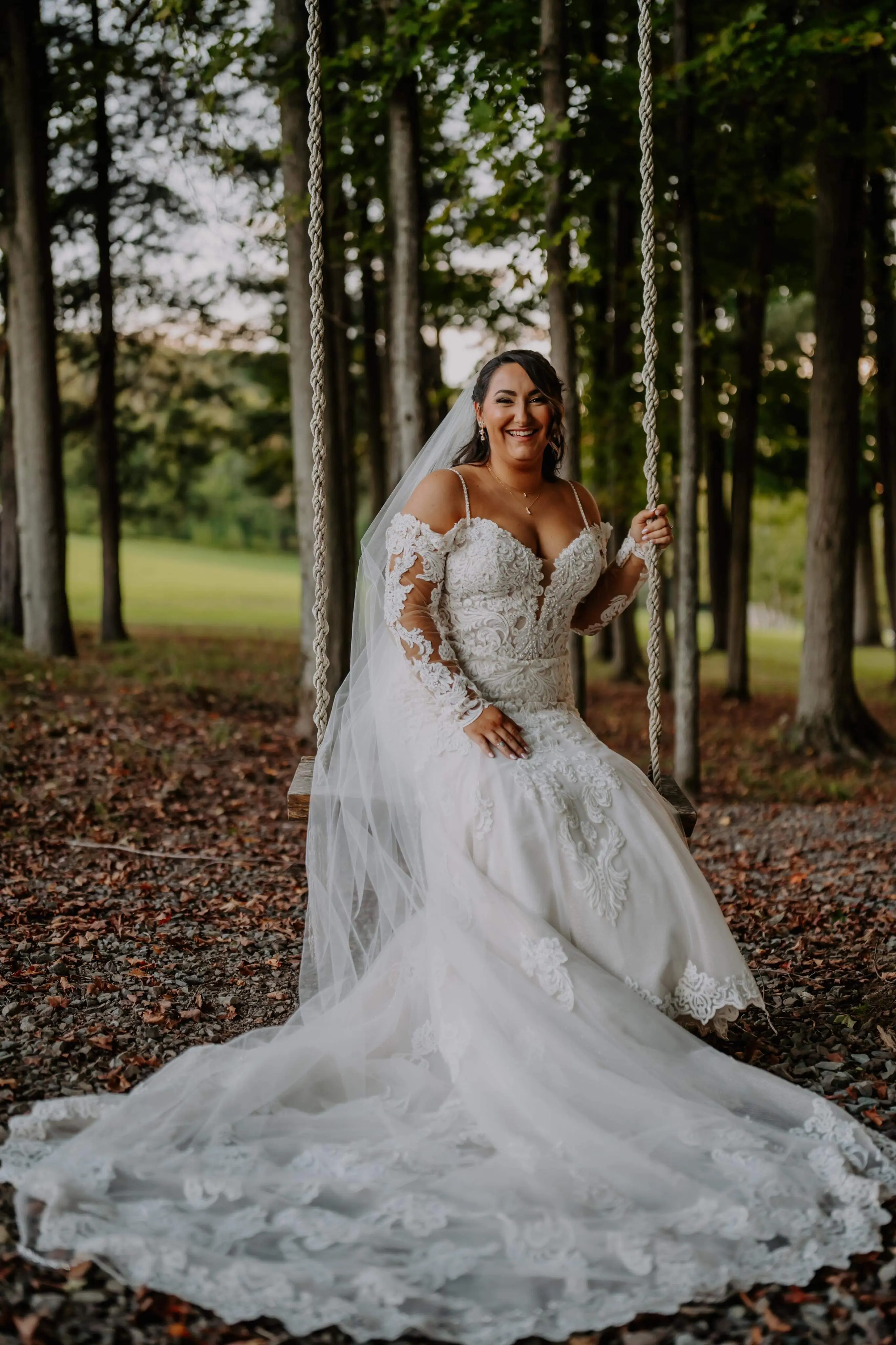 Bride wearing Fiona wedding dress by Maggie Sottero on a swing