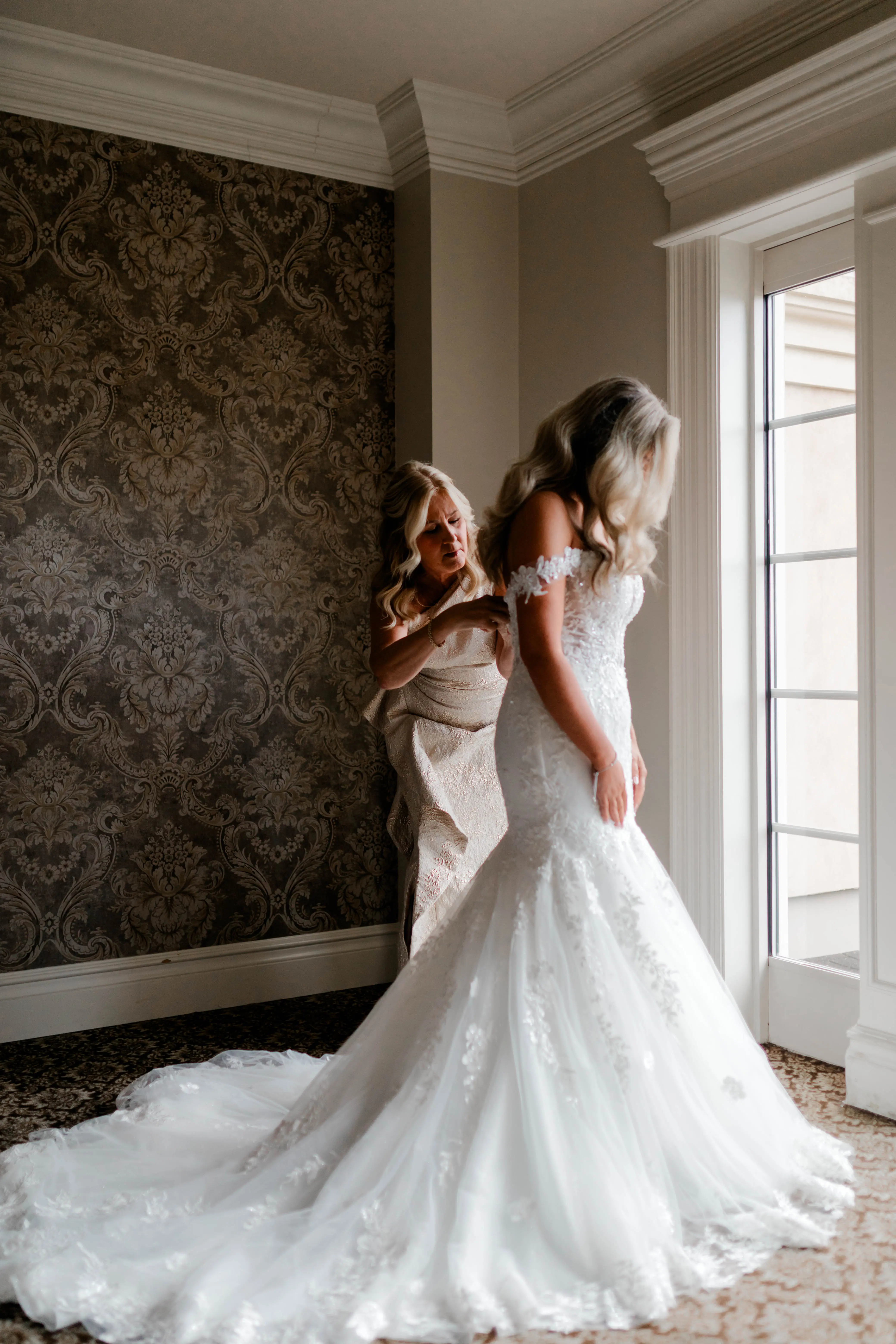 Bride wearing Lennon by Maggie Sottero being buttoned up