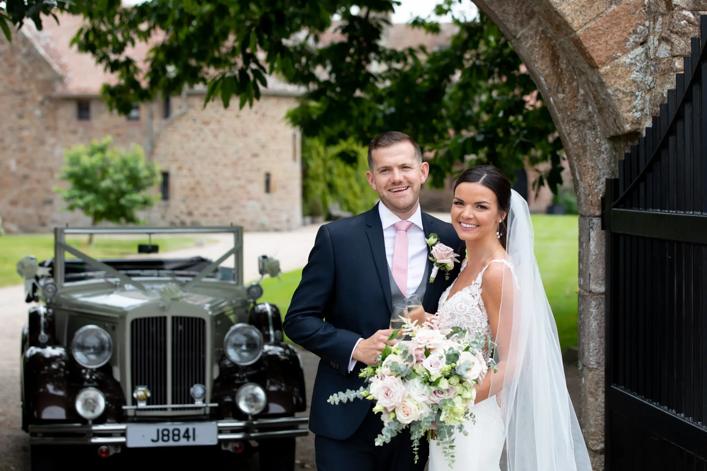 Bride with groom wearing crepe sheath wedding dress