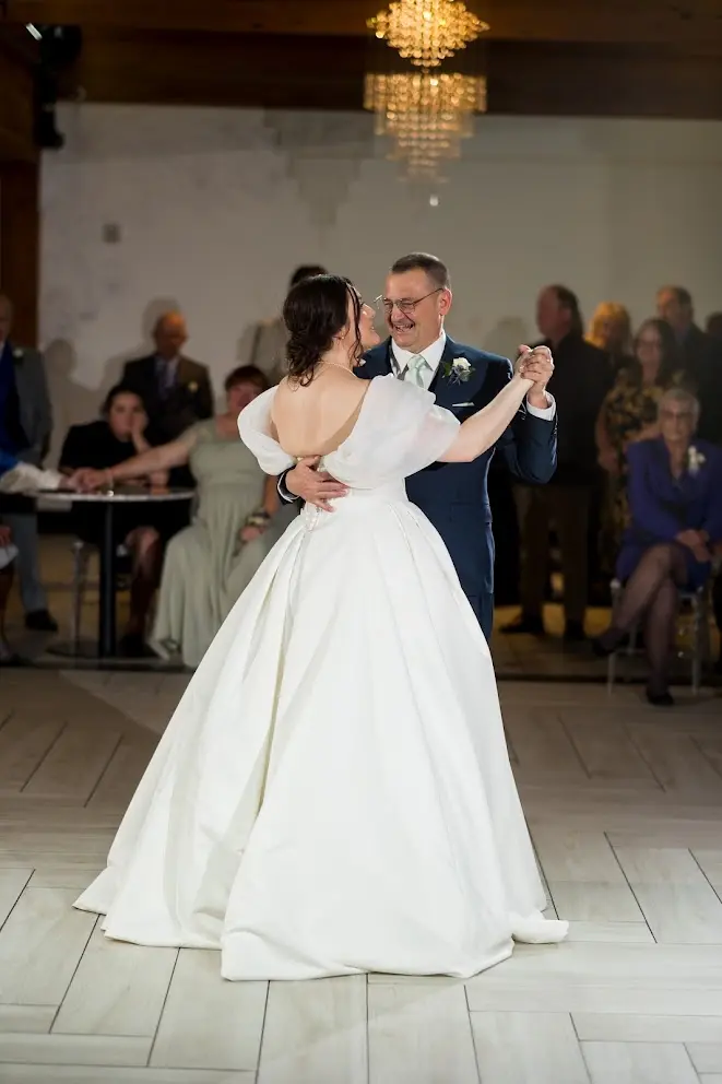Bride wearing Derrick by Maggie Sottero dancing with a loved one
