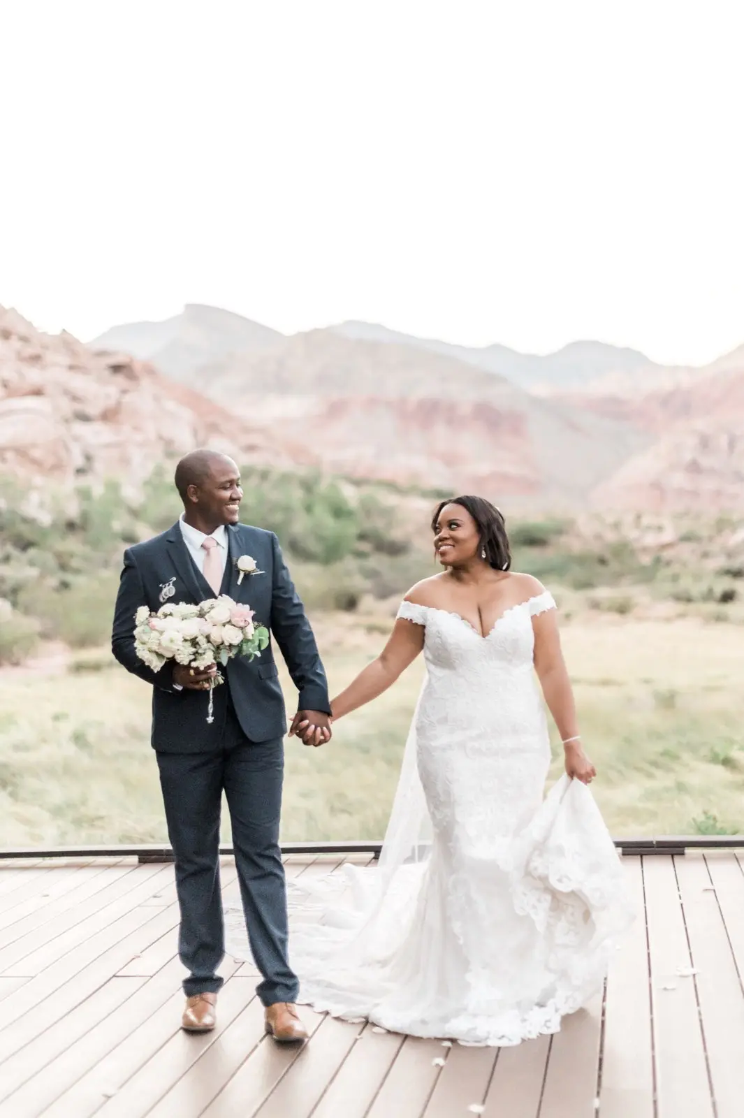 Bride with groom wearing off the shoulder lace wedding dress