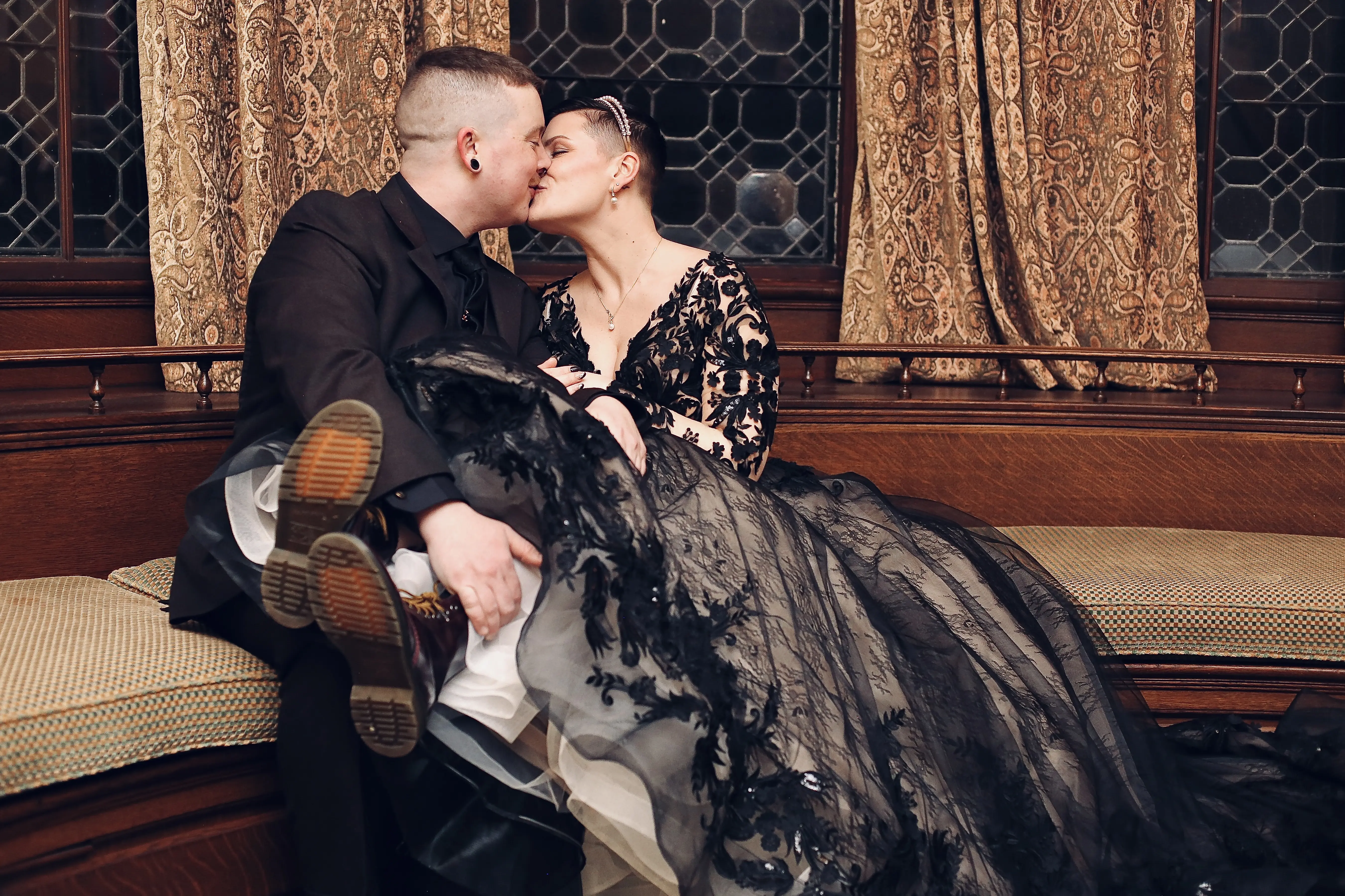 Groom Kissing Bride In Black Wedding Dress Named Zander By Sottero and Midgley
