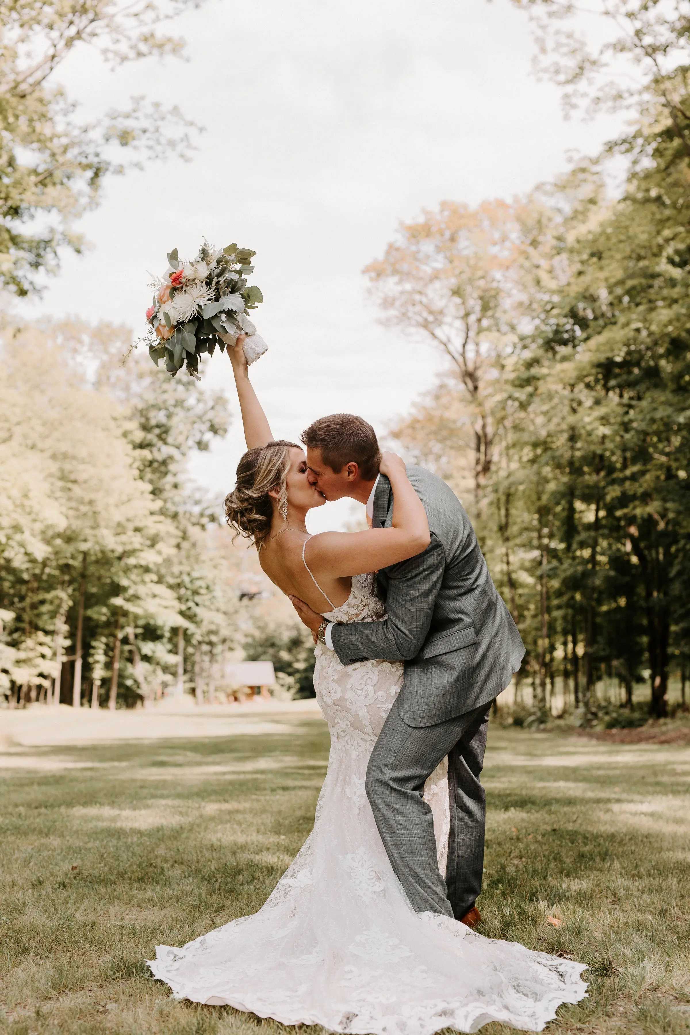 Bride Wearing Lace Sexy Wedding Dress Called Tuscany Lynette By Maggie Sottero With Kissing Groom