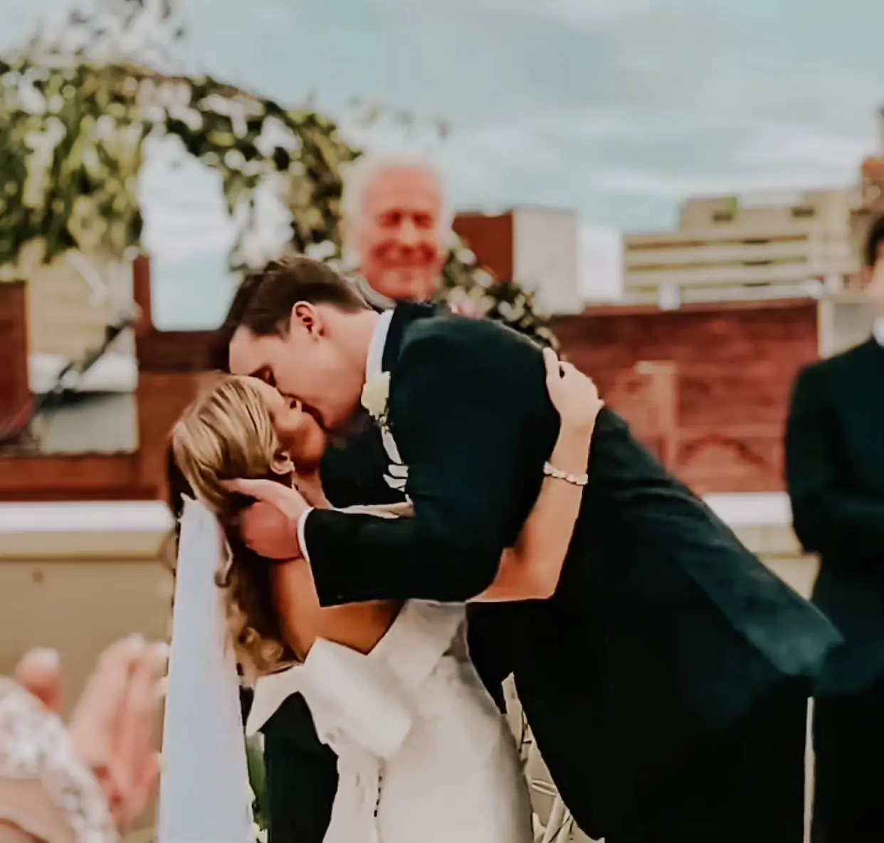 Bride with groom wearing unique strapless wedding dress