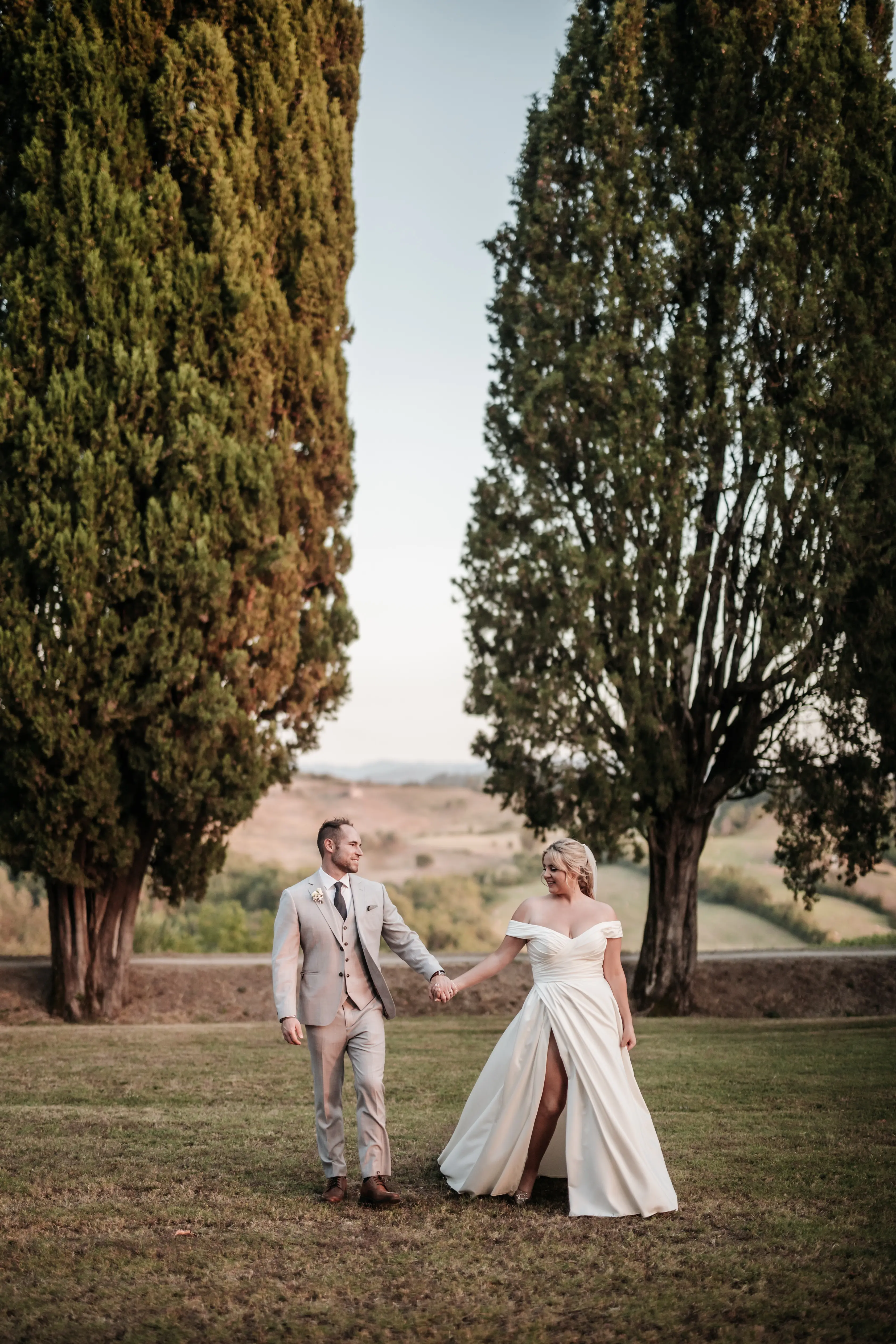 Groom With Bride Wearing A-Line Satin Off-The-Shoulder Satin Wedding Dress Ekaterina By Maggie Sottero
