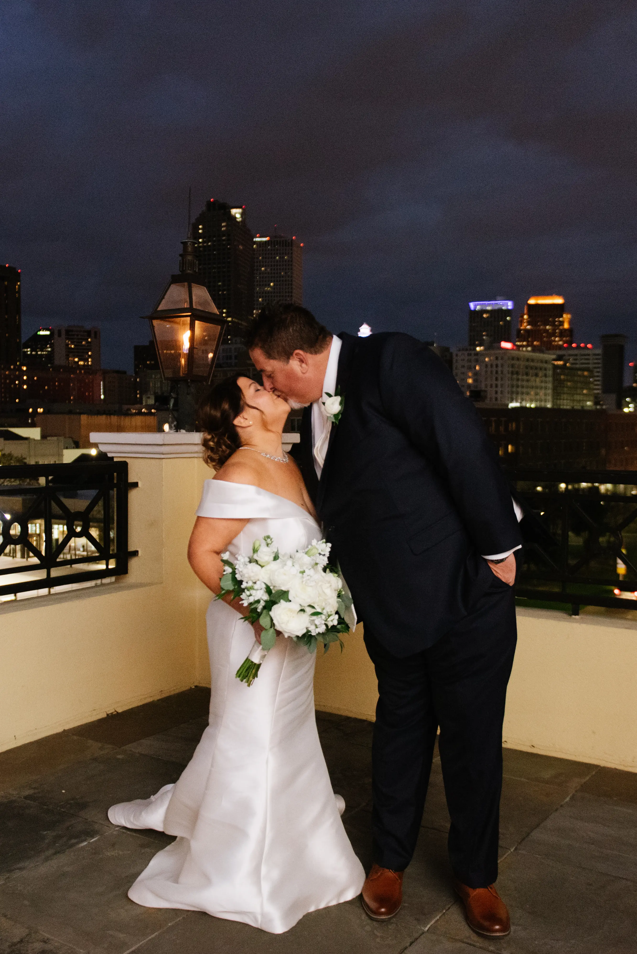 Bride with groom wearing elegant off the shoulder wedding dress
