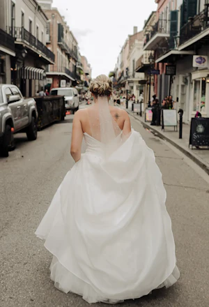 Bride Wearing Modern Princess Wedding Dress Called Aubrielle By Maggie Sottero Walking Through The Streets Of New Orleans