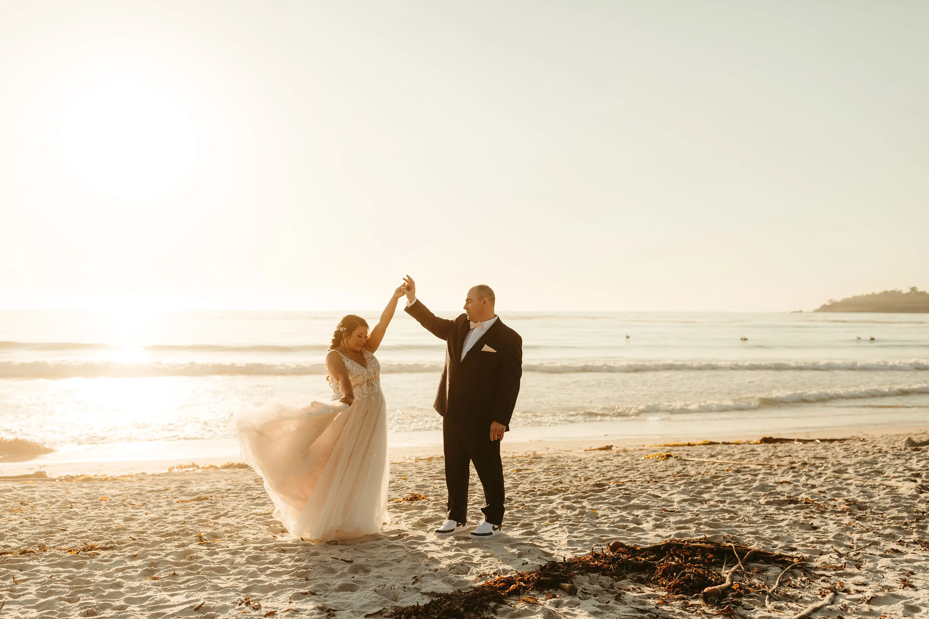 Bride with groom wearing affordable A-Line floral motif wedding dress.