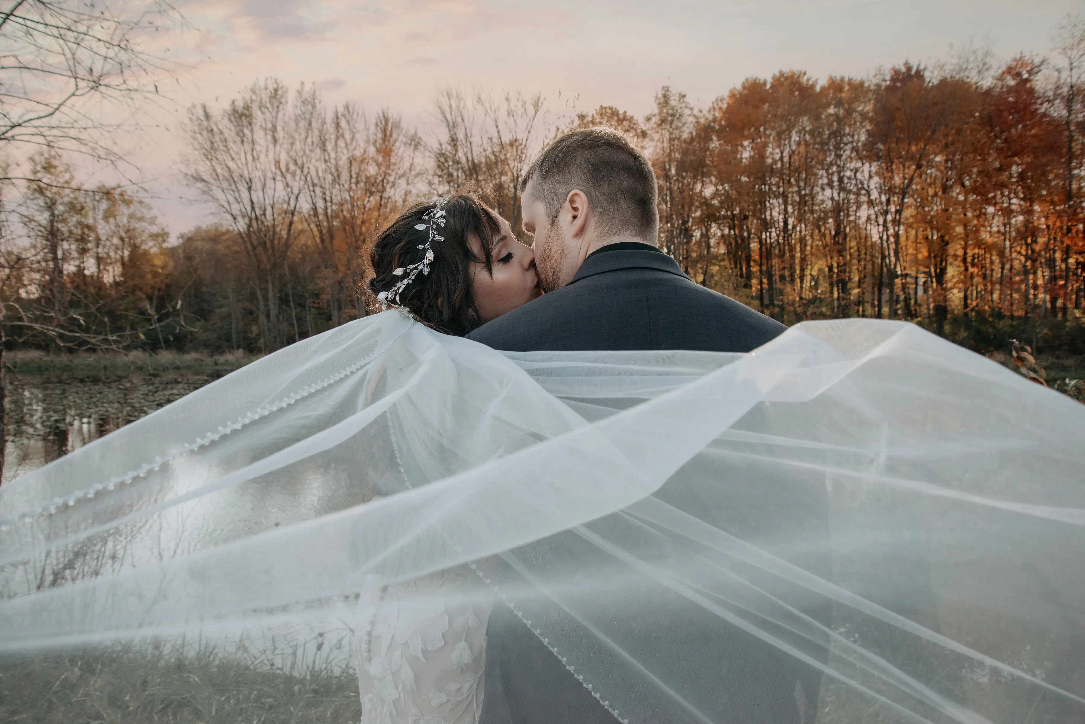 Bride wearing Mermaid Lace wedding dress called Hattie by Rebecca Ingram kissing the groom