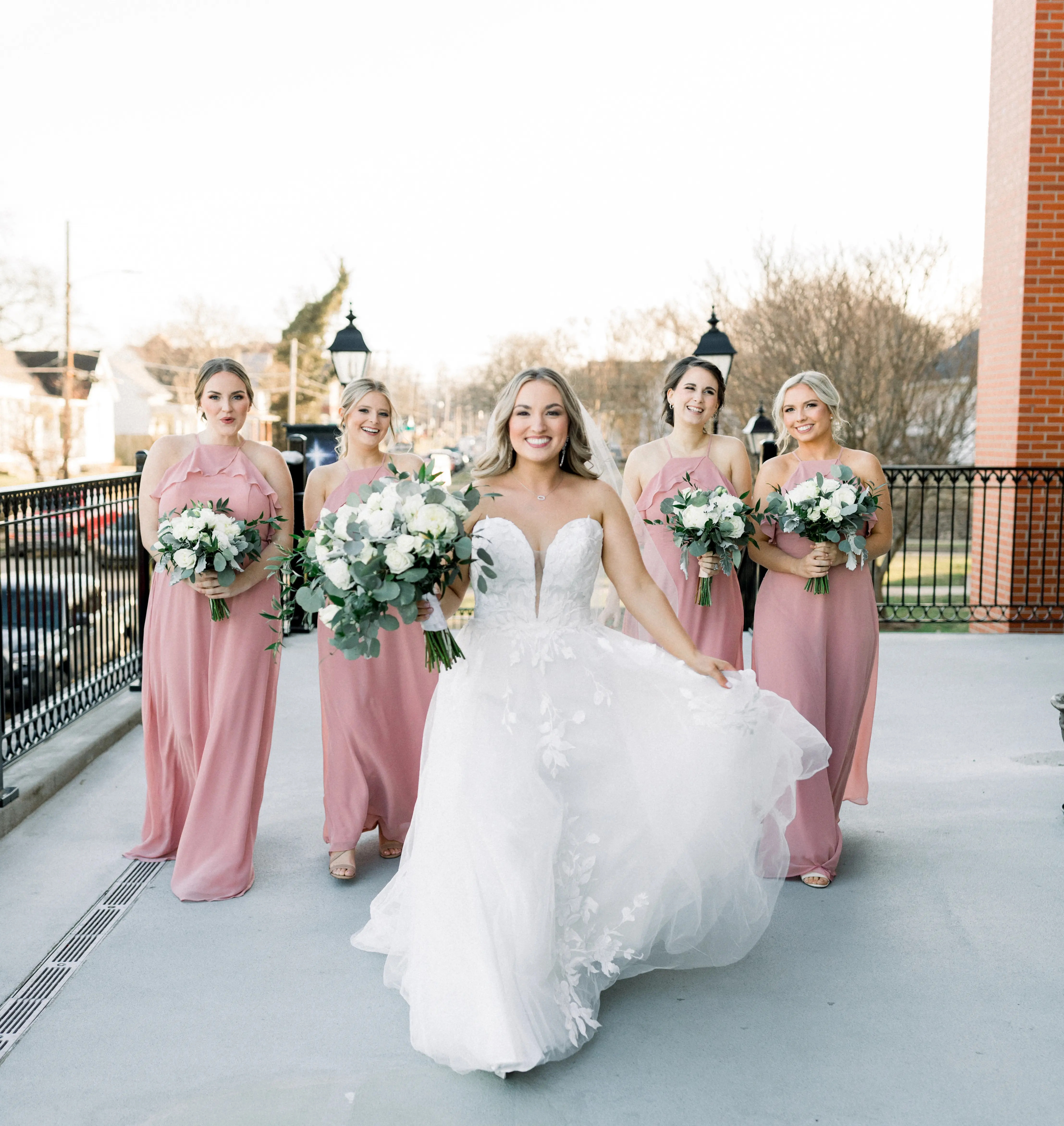 Bride wearing Hattie Lane Marie wedding dress by Rebecca Ingram with bridesmaids
