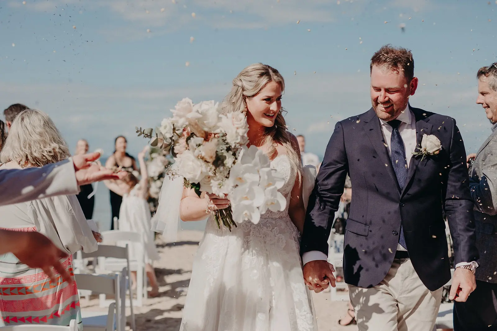 Bride Wearing Off-The-Shoulder Lace Wedding Dress Called Carson By Sottero And Midgley With Groom After The Ceremony