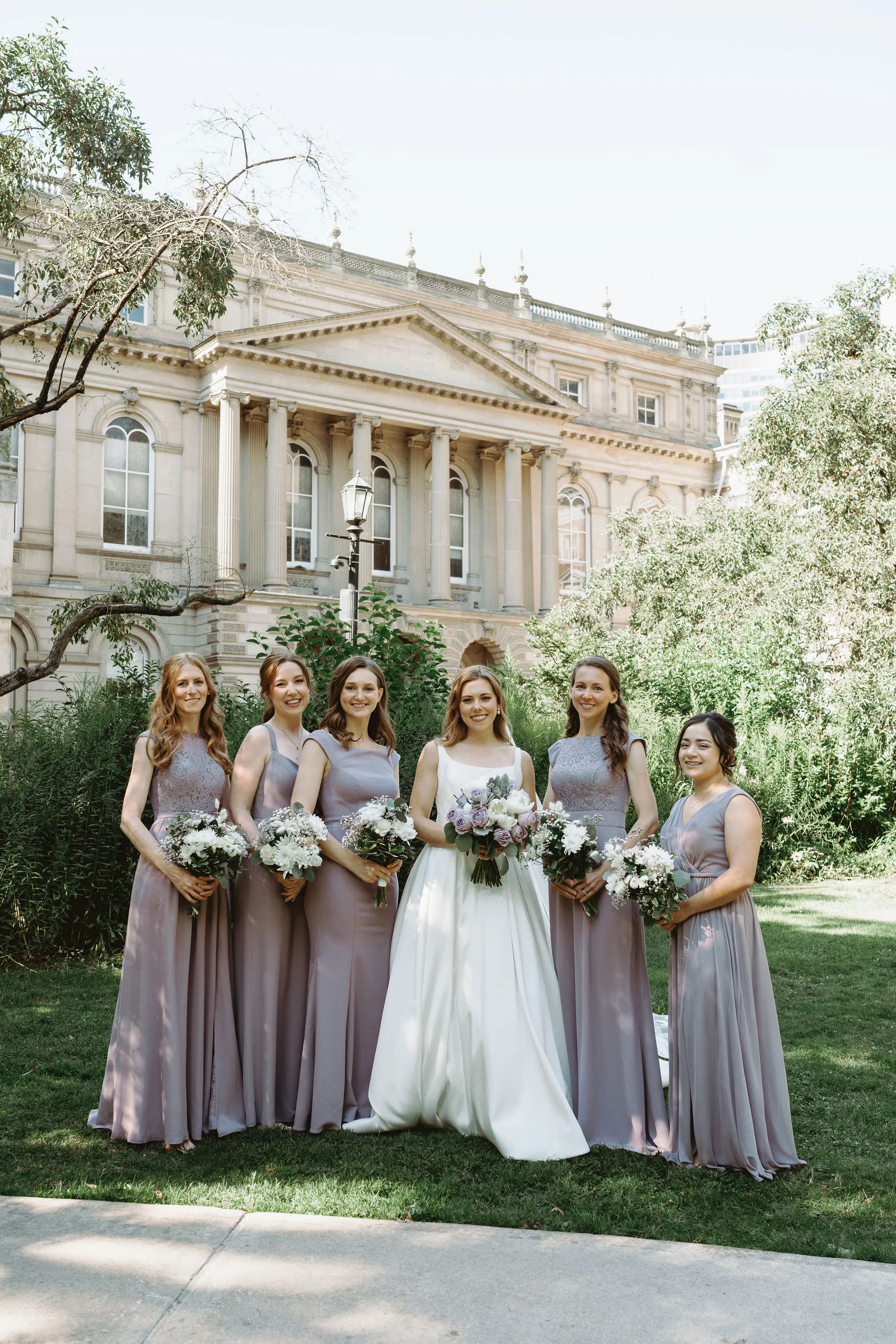 Bride wearing Selena wedding gown by Maggie Sottero with her bridesmaids