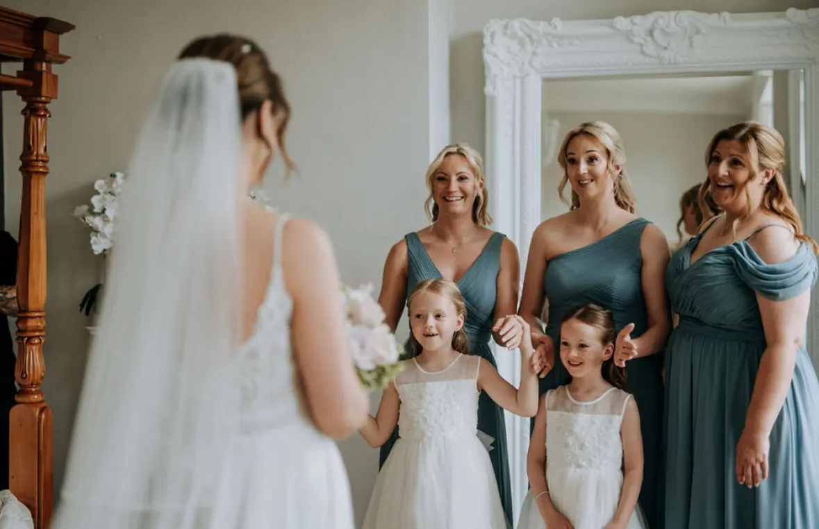 Bride wearing Lorraine by Rebecca Ingram doing a first look with her bridesmaids and flower girls