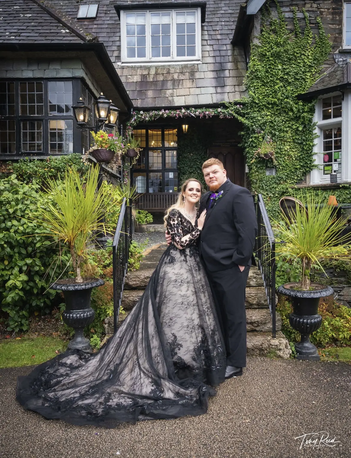Groom with Bride In A Black Lacey Long Sleeved Ball Gown Wedding Dress Named Zander By Sottero And Midgley