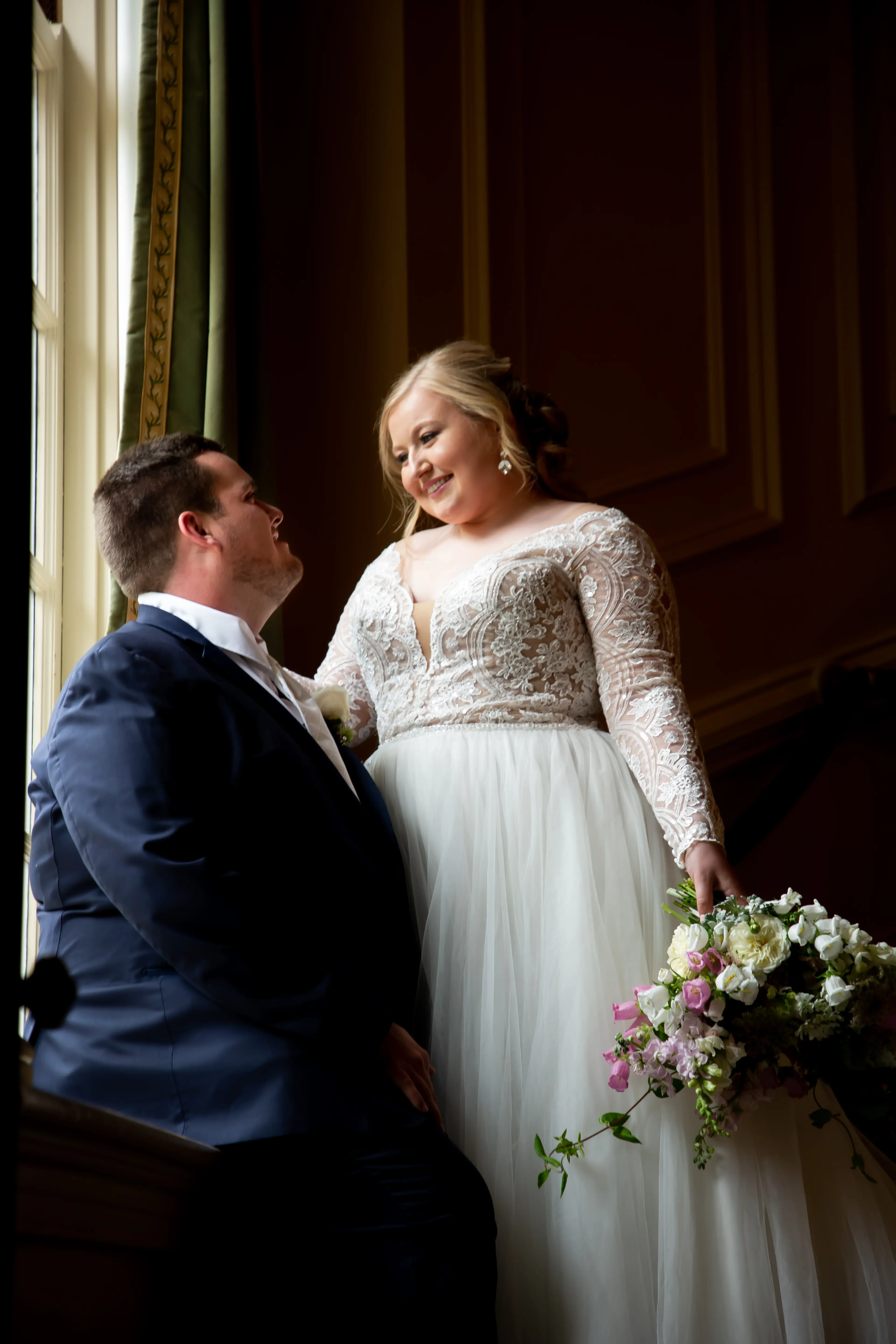 Bride With Groom Holding Flower Bouquet Wearing Wedding Dress Called Mallory Dawn by Maggie Sottero