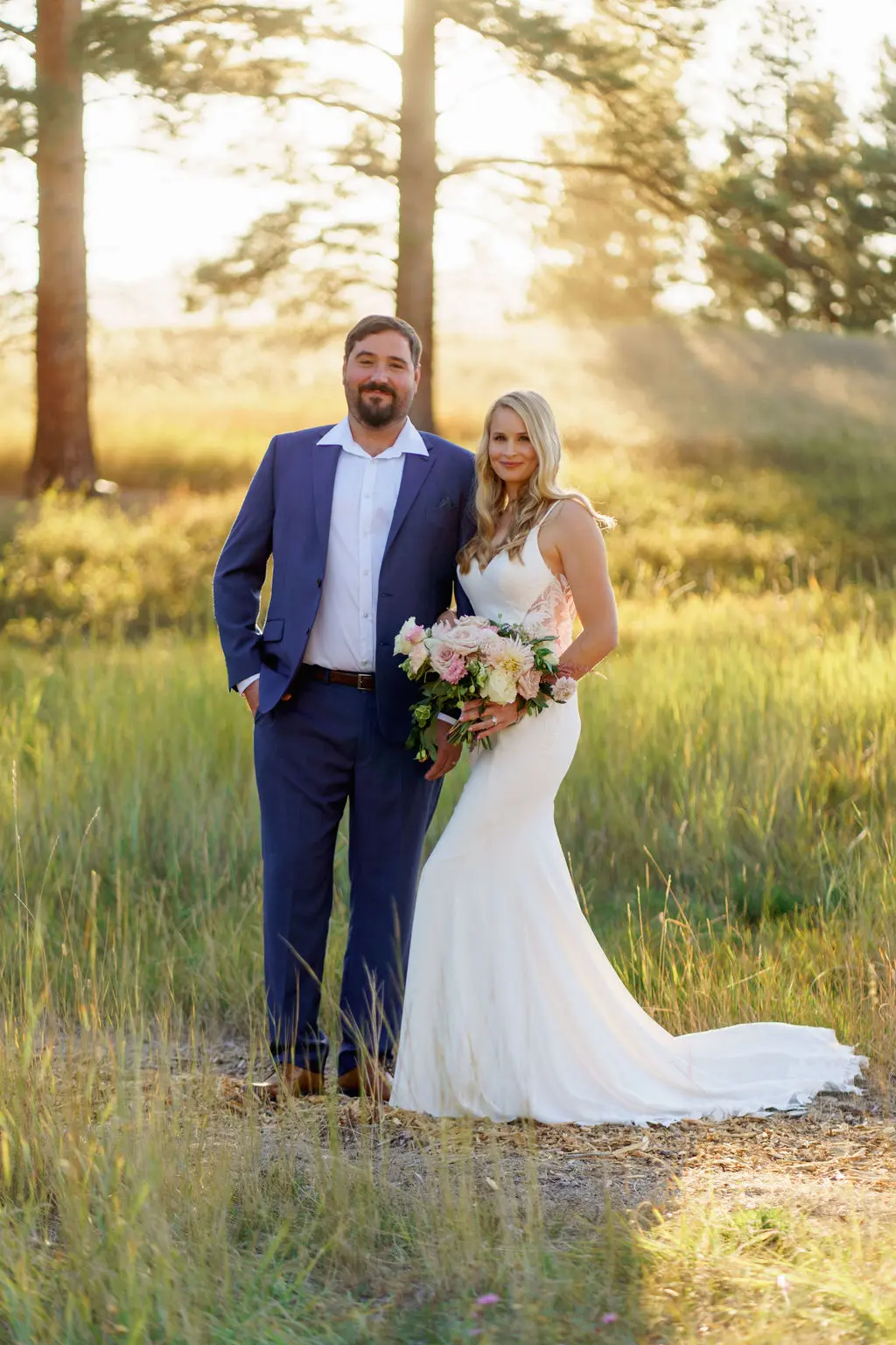Bride wearing Dionne wedding dress by Rebecca Ingram standing with her husband