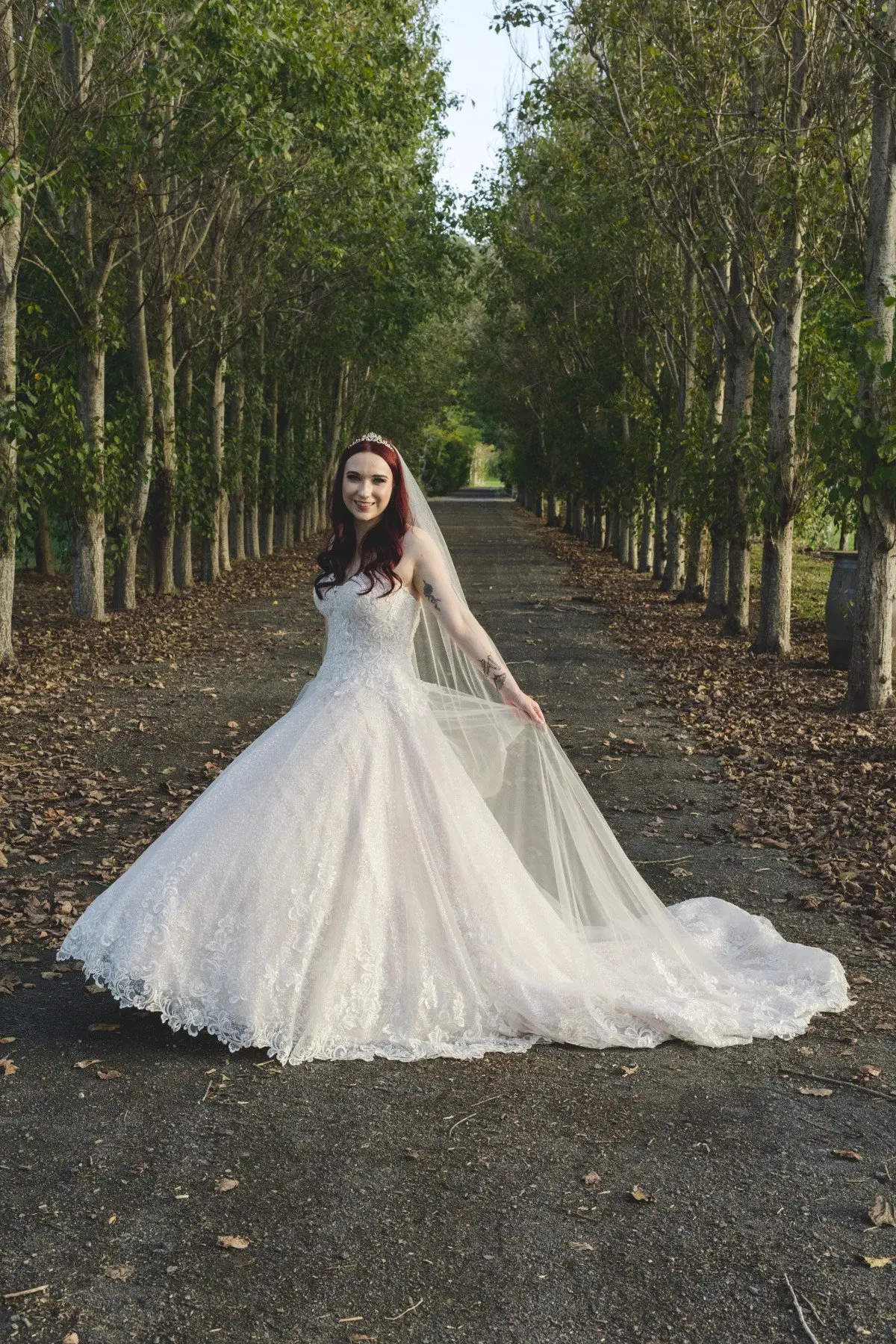 Bride in Lace Ball Gown Wedding Dress with Sequined Tulle and Lace Motifs over Bodice and Statement Hemline called Tristyn by Maggie Sottero