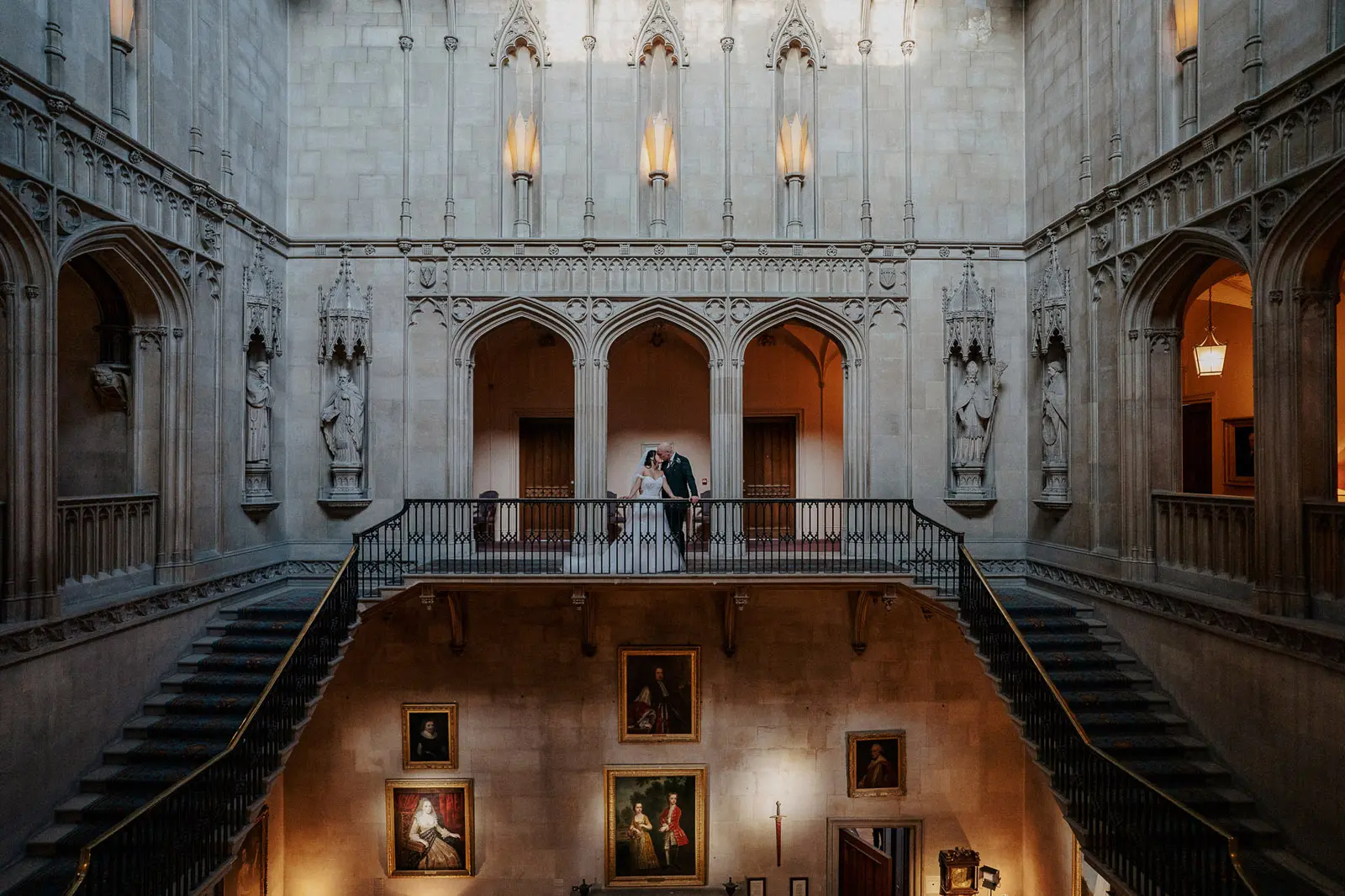 Bride wearing Harlem by Maggie Sottero kissing her husband in a castle