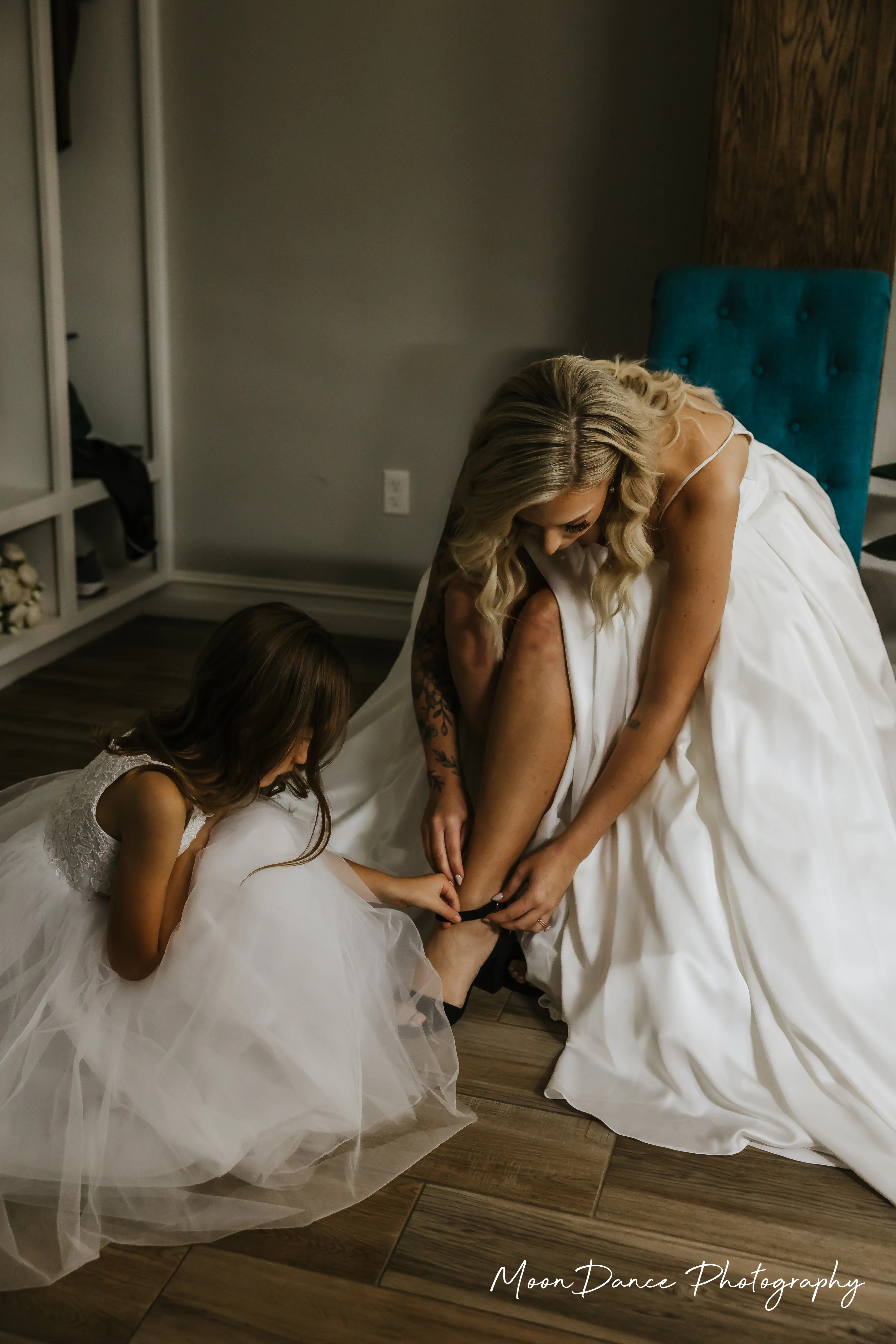 Bride Wearing Aline Satin Wedding Gown Called Scarlet By Maggie Sottero With Flower Girl Helping Her Get Ready